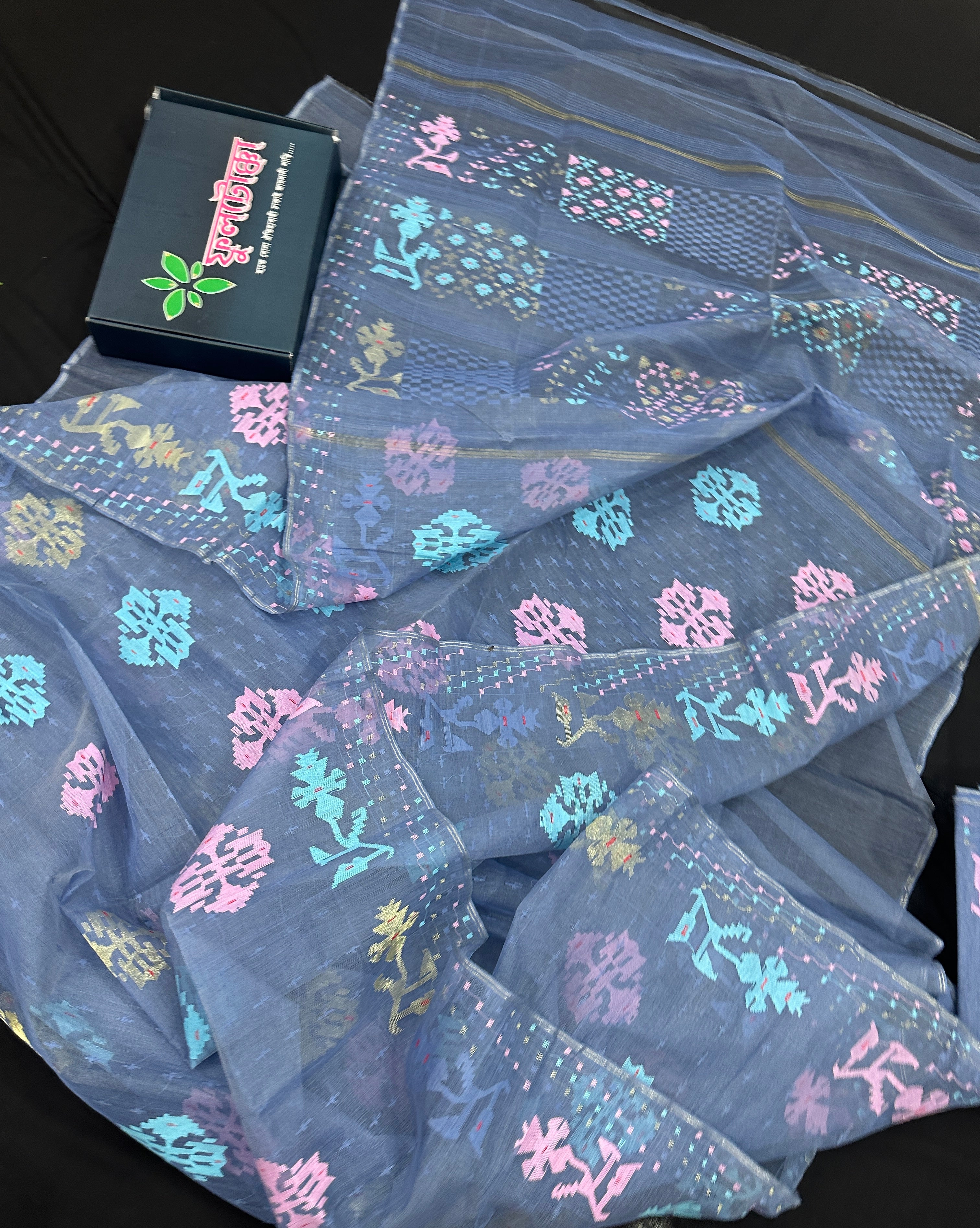 Powdery blue jamdani saree with pink blue and golden jori work.