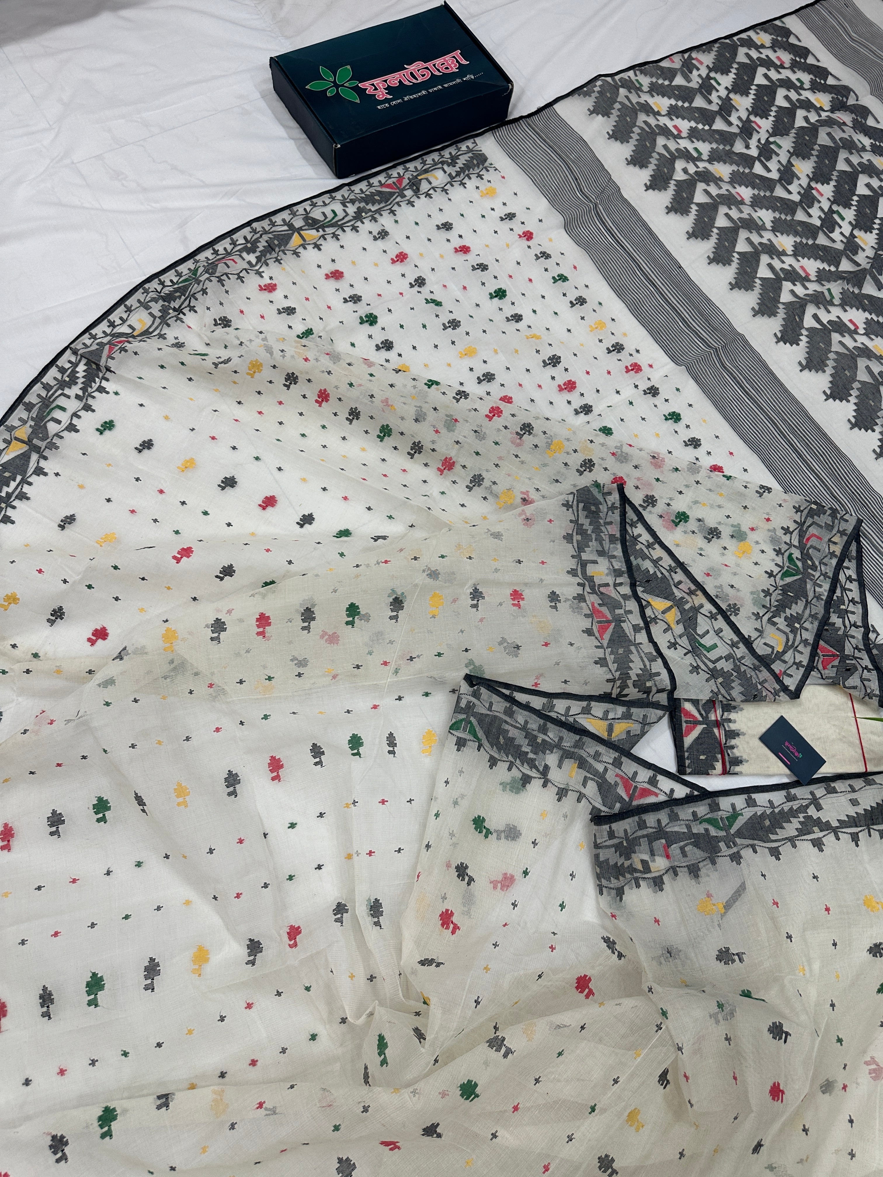 White cotton jamdani saree with black red yellow green threads work & blouse piece.