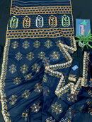 Navy blue jamdani saree with orange  green & off white threads work.