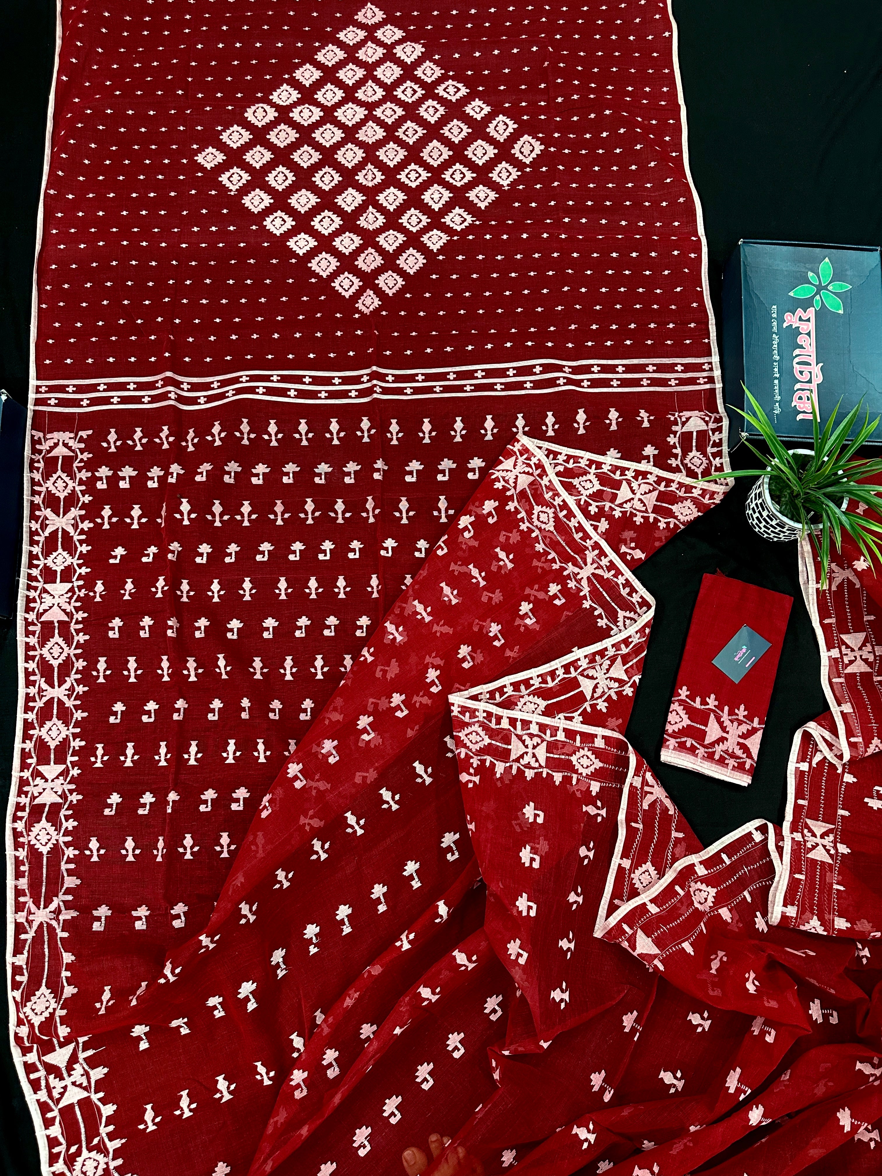 Maroon jamdani saree with white thread work.