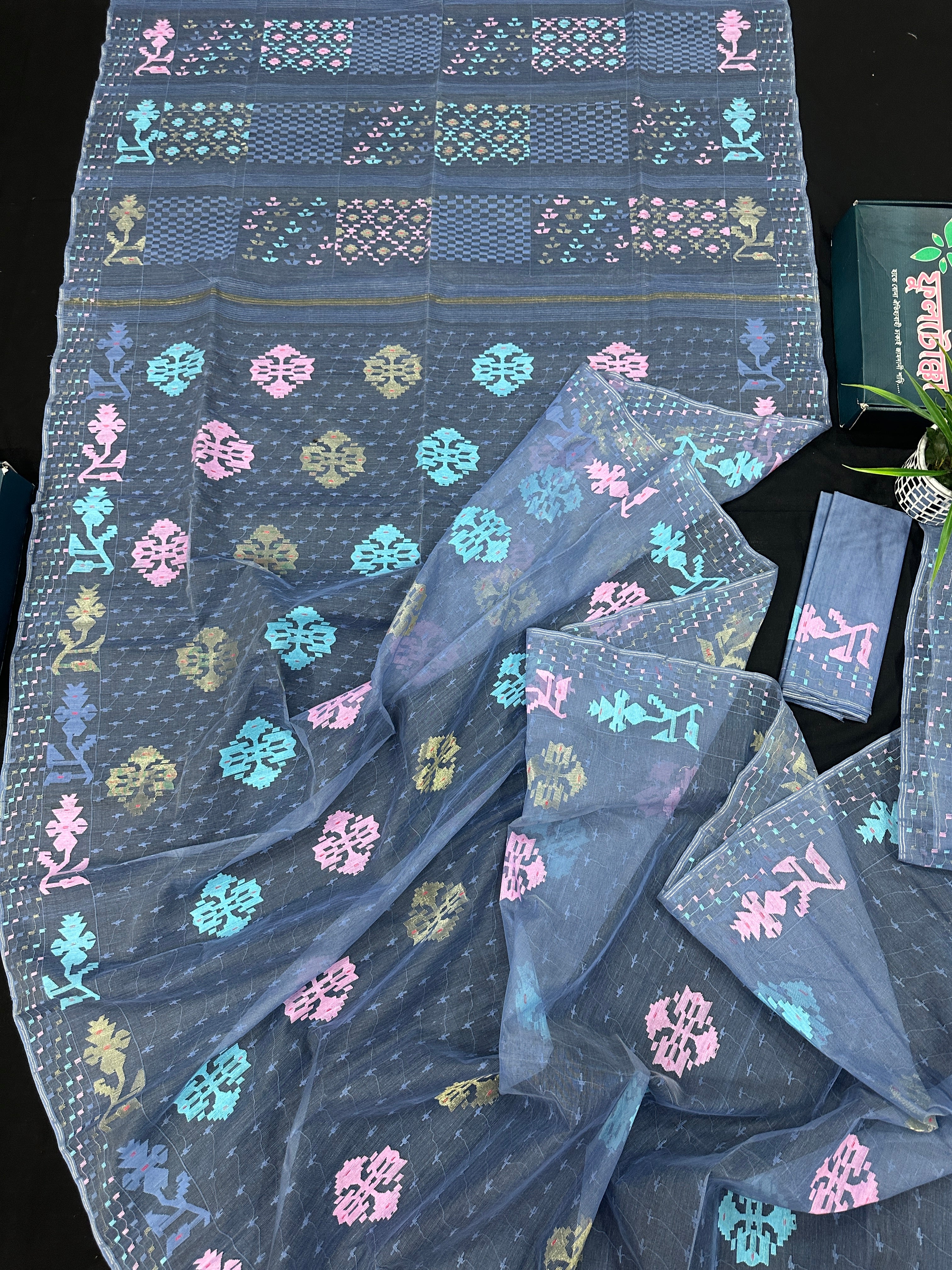 Powdery blue jamdani saree with pink blue and golden jori work.