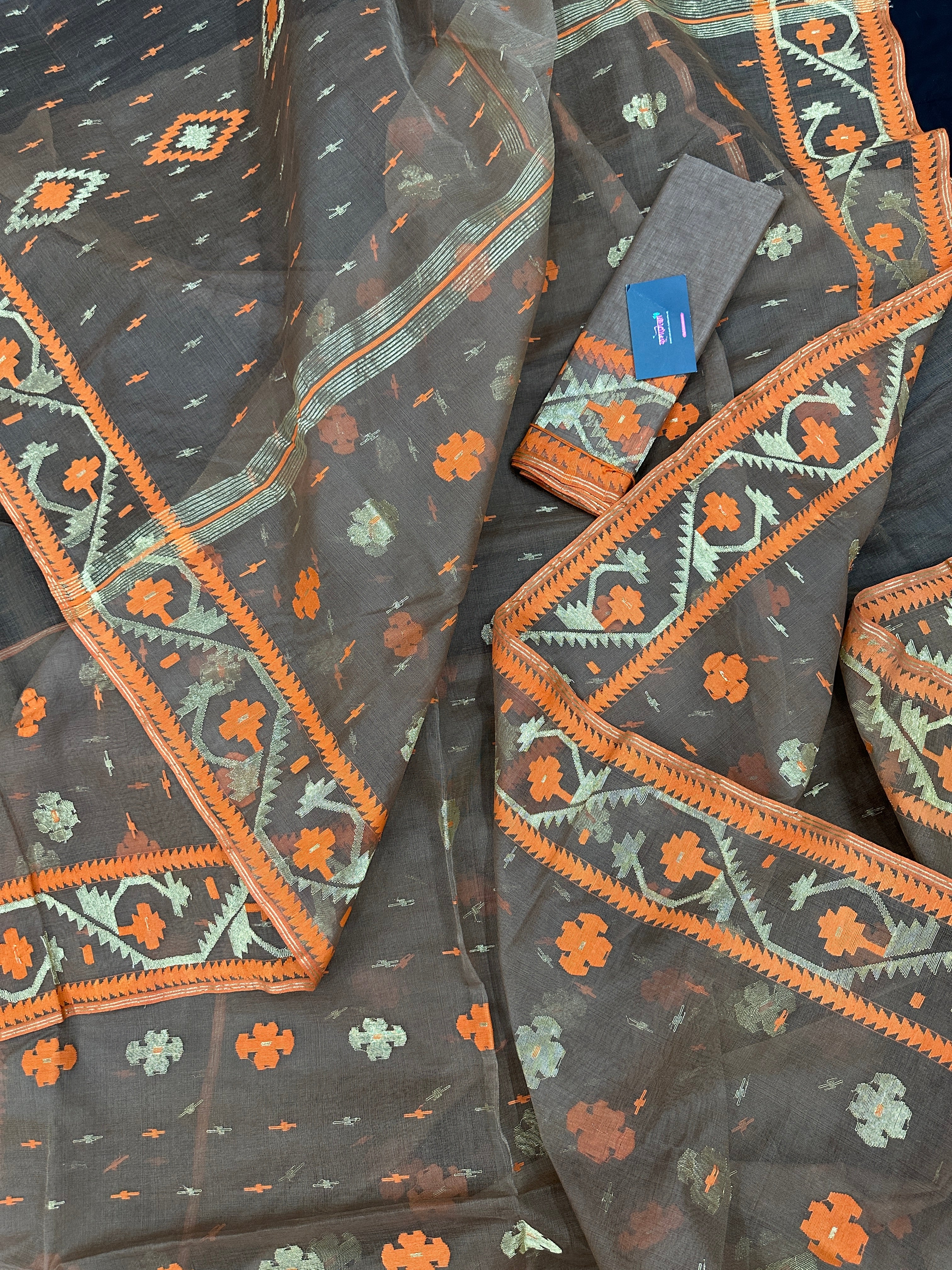 Peanut Brown dhakai jamdani saree with orange threads work & golden jori work all over soft count.