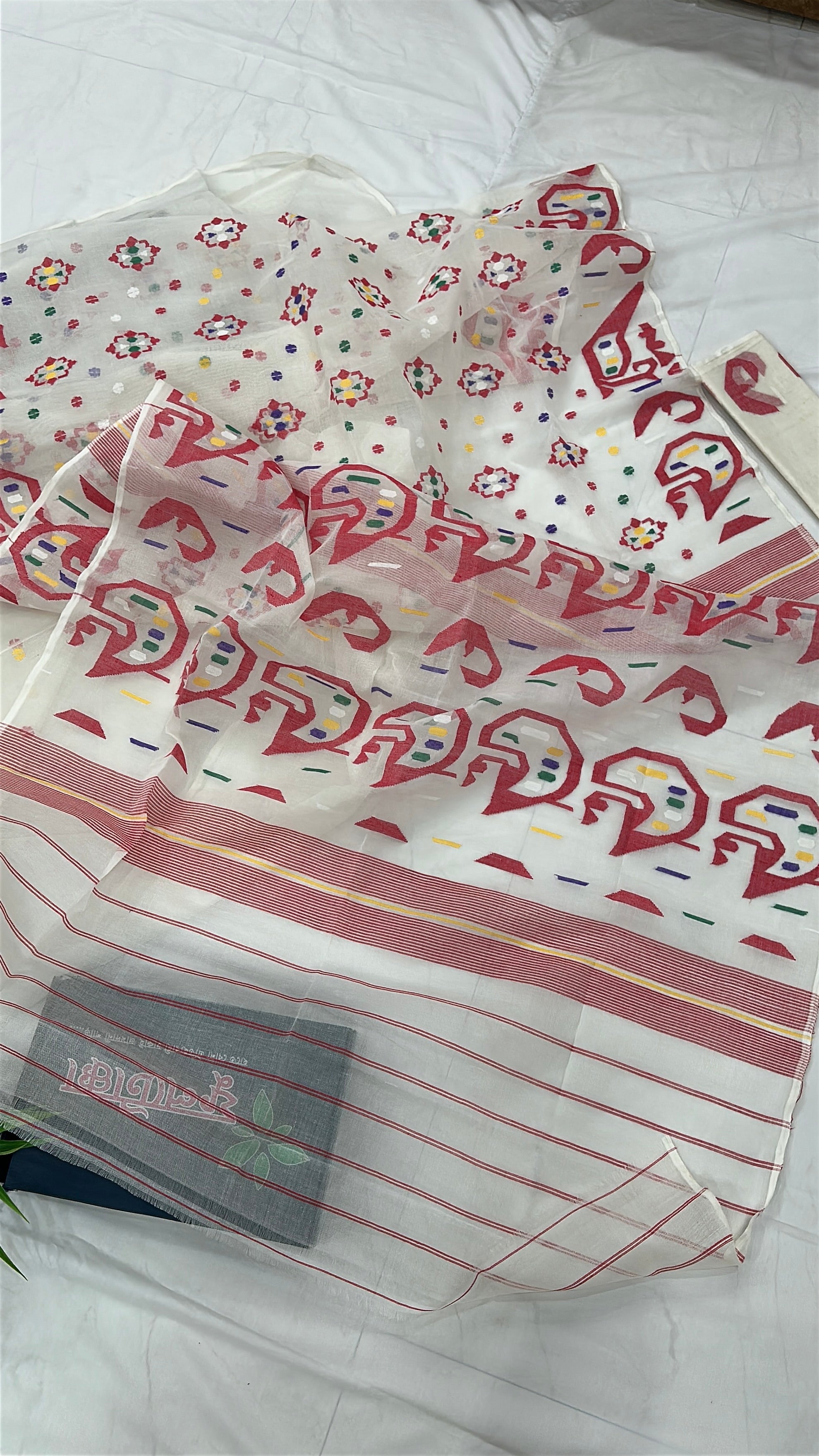 White cotton jamdani saree with multiple colour threads work and blouse piece.