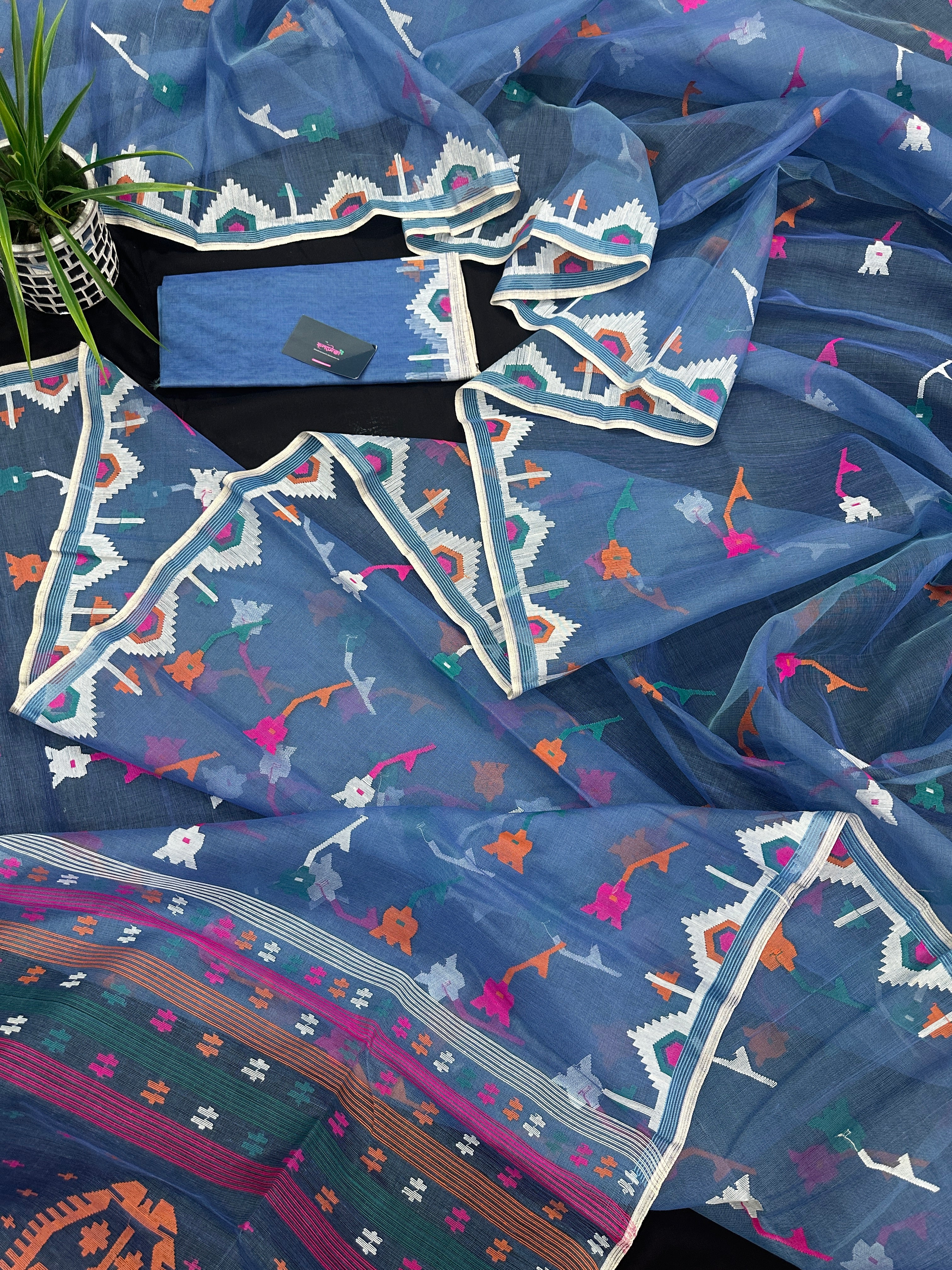 Dusty blue jamdani saree with pink white blue green work and white paar.