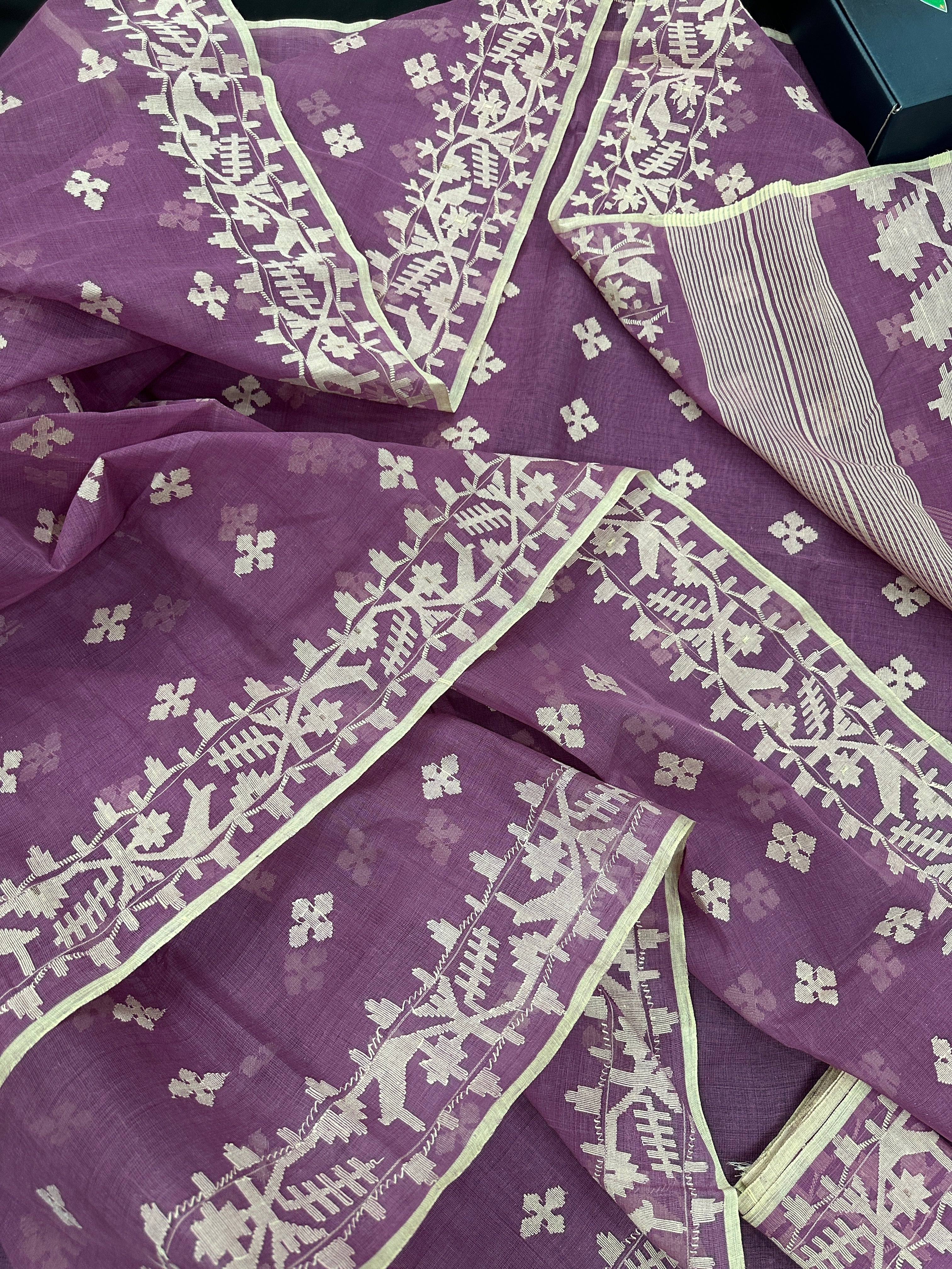 Onion cotton jamdani saree with yellowish threads work all over work.
