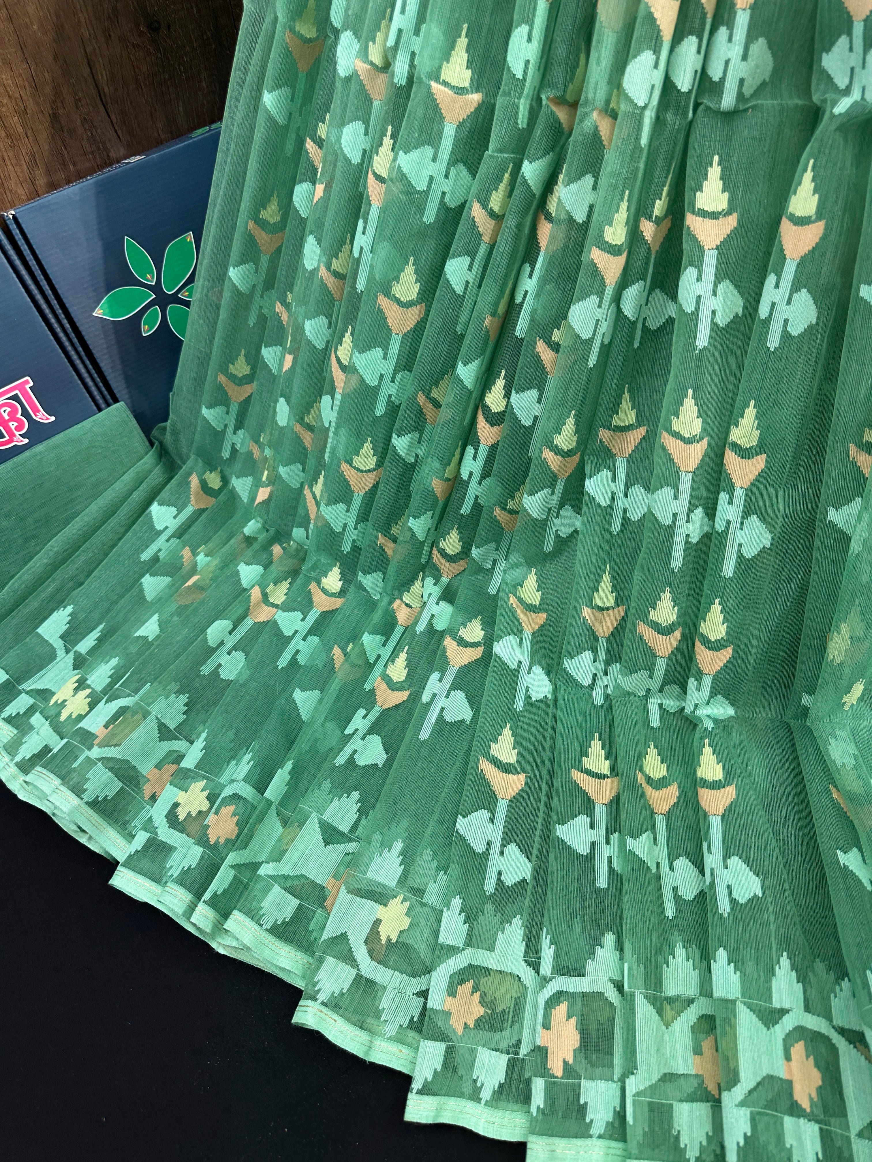 Jade green halfsilk jamdani saree with green off white golden self threads work