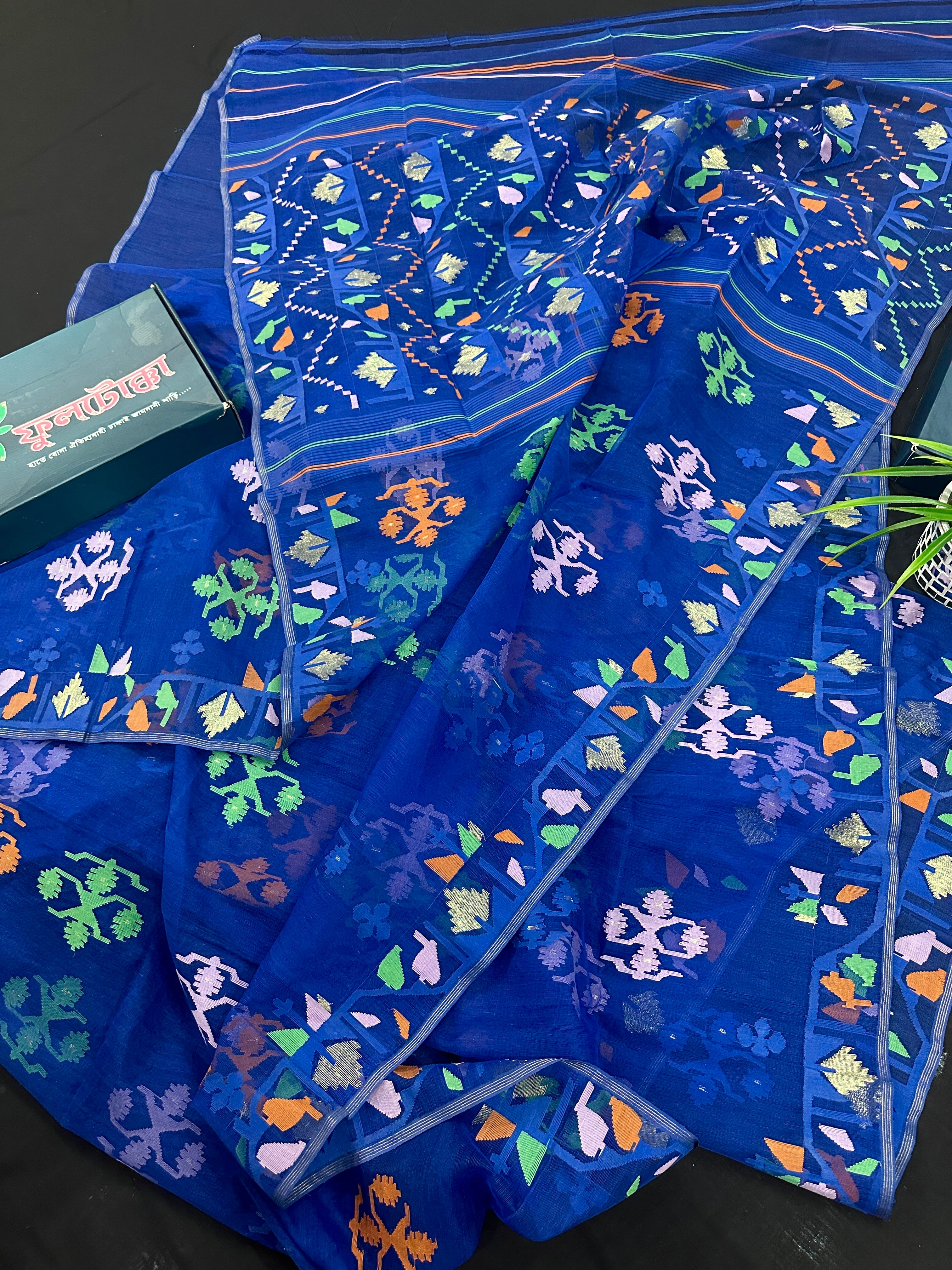 Royal blue jamdani saree with green pink blue orange threads work.
