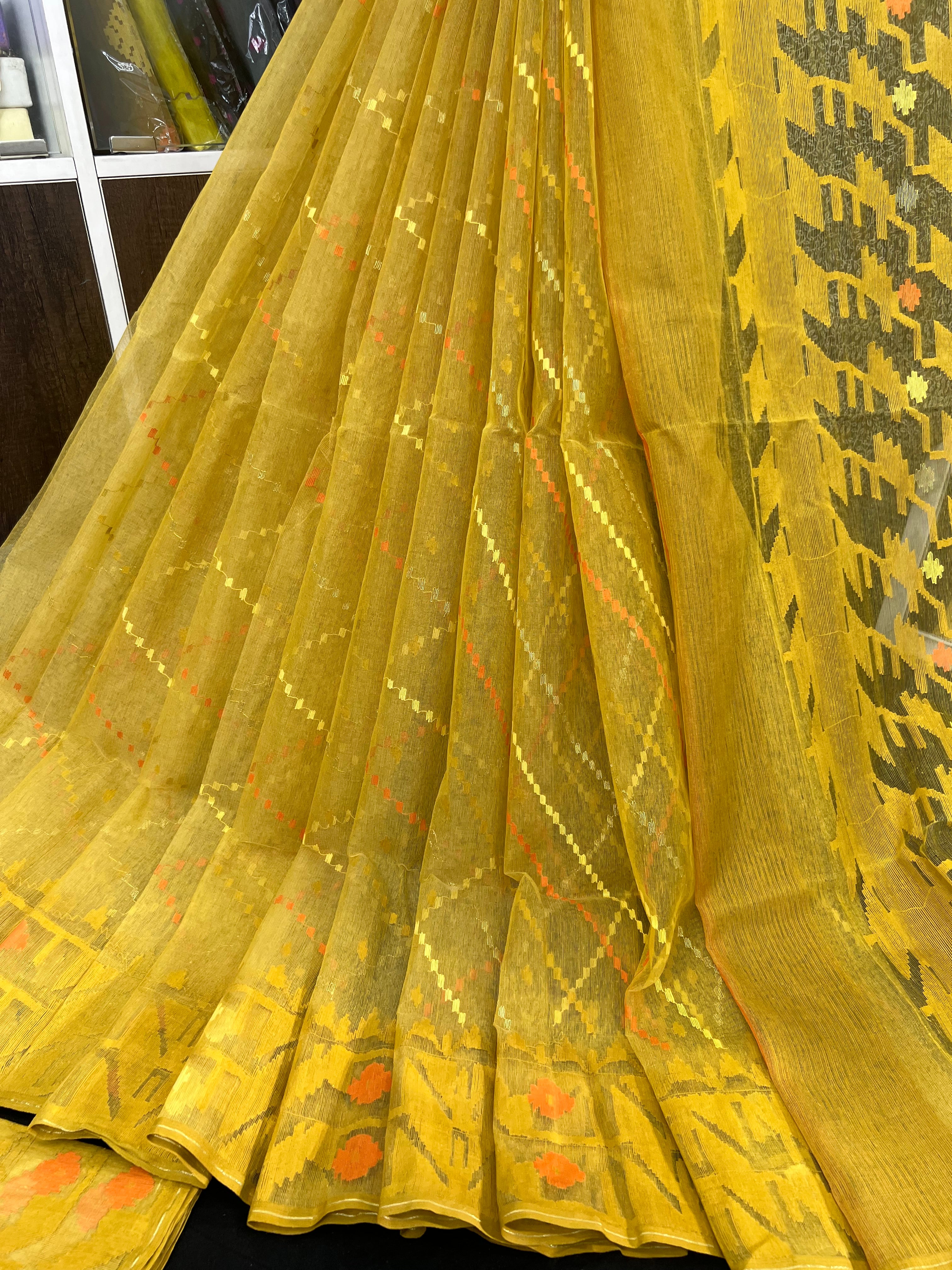 Yellow halfsilk jamdani saree with yellow orange threads work