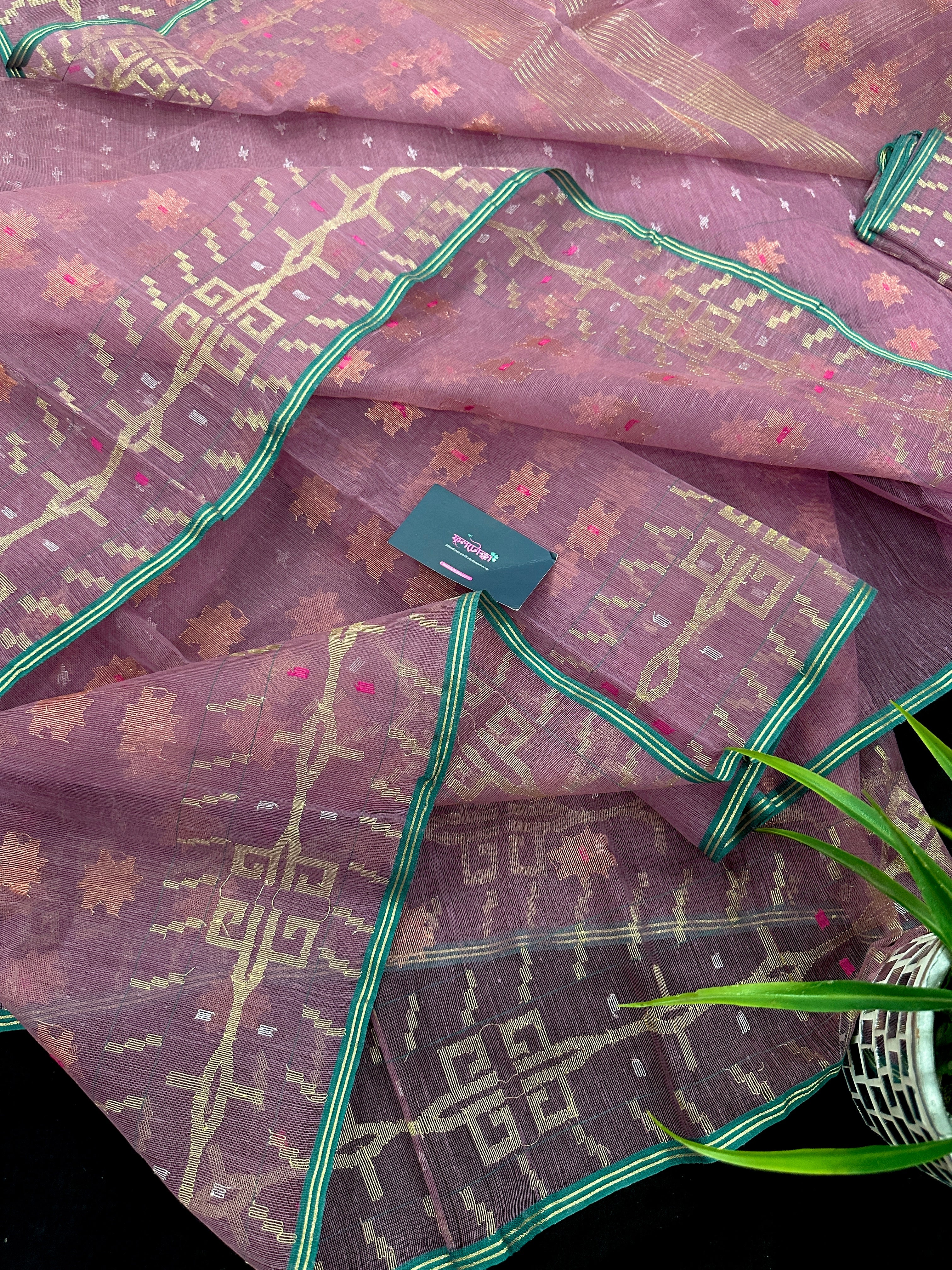 Onion colour jamdani saree with pink meena and green border.
