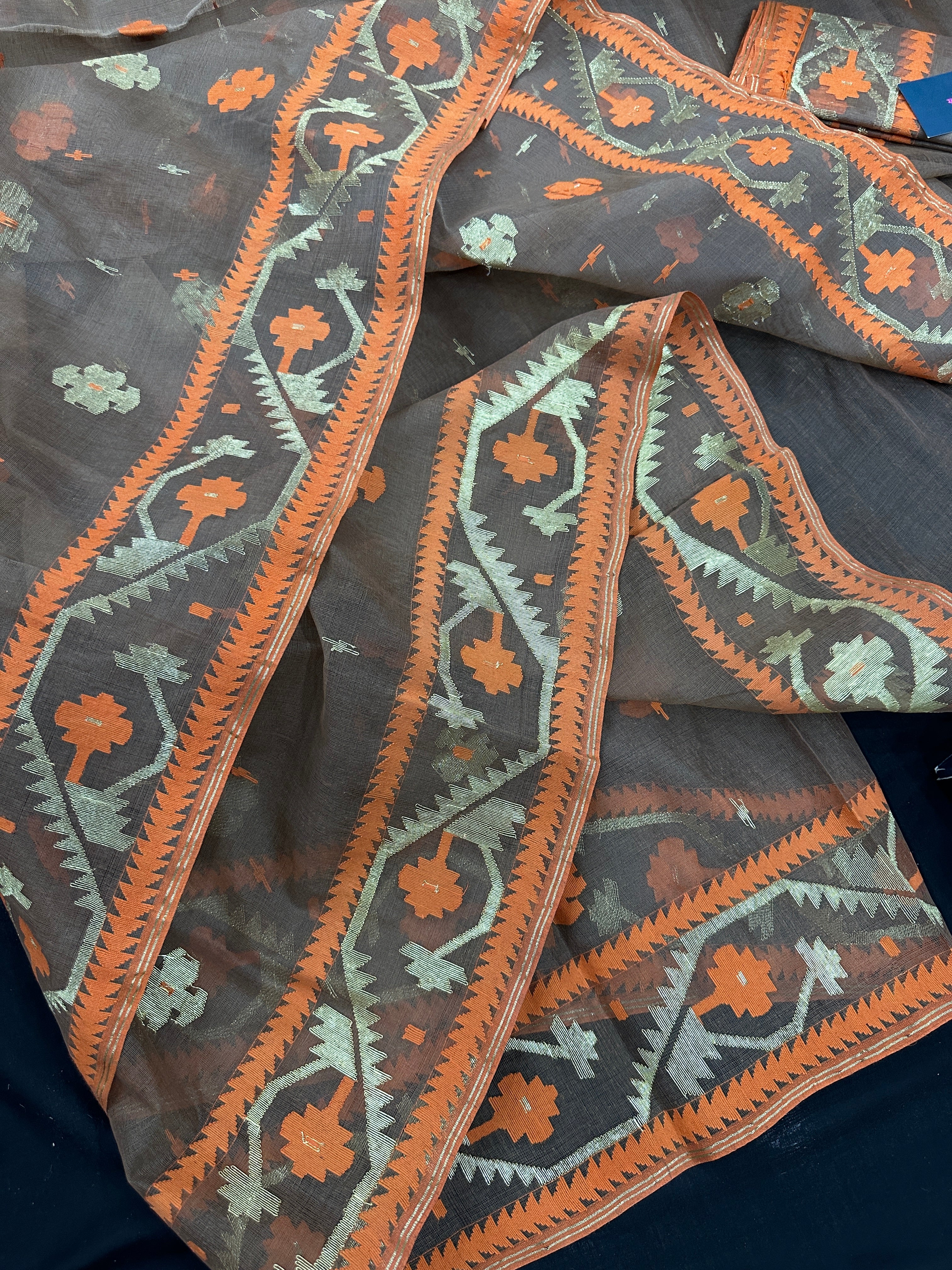 Peanut Brown dhakai jamdani saree with orange threads work & golden jori work all over soft count.