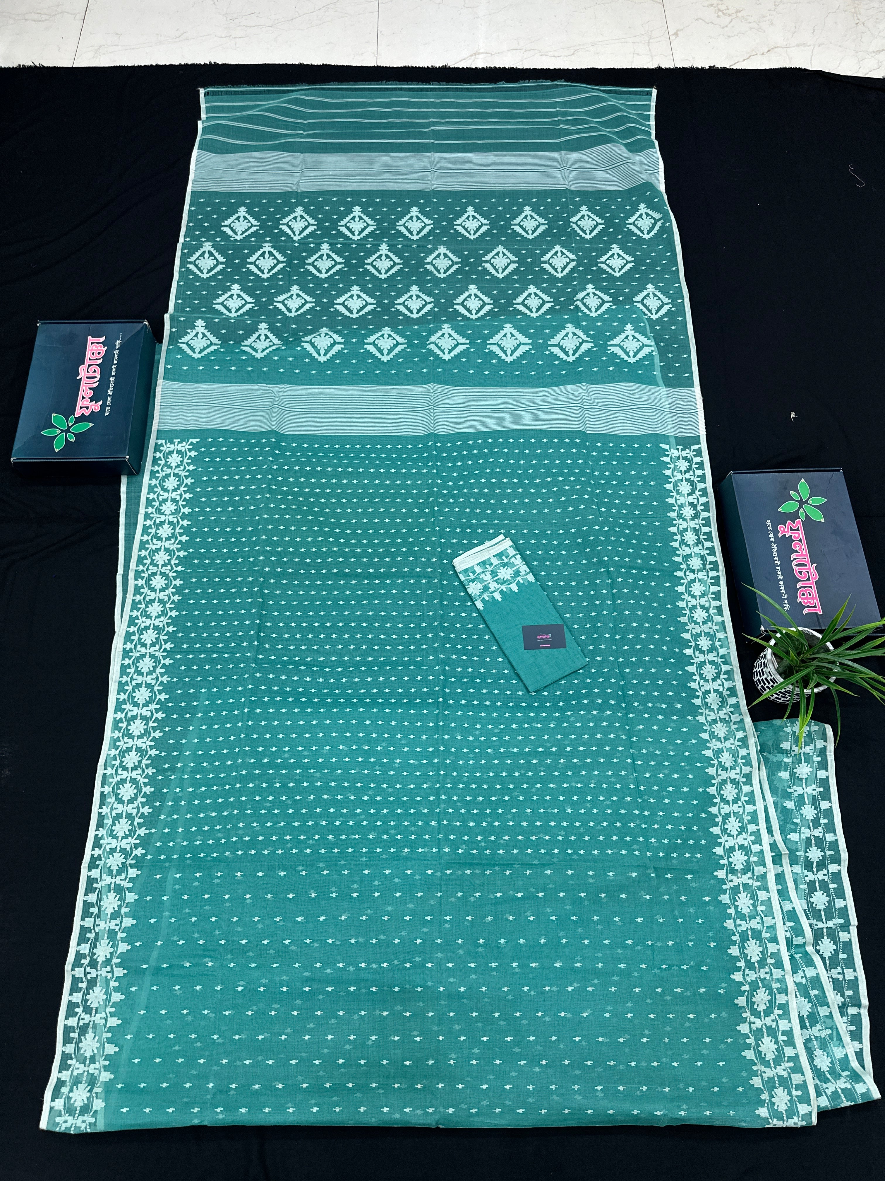 Mint cotton jamdani saree with white threads work all over work and blouse piece.