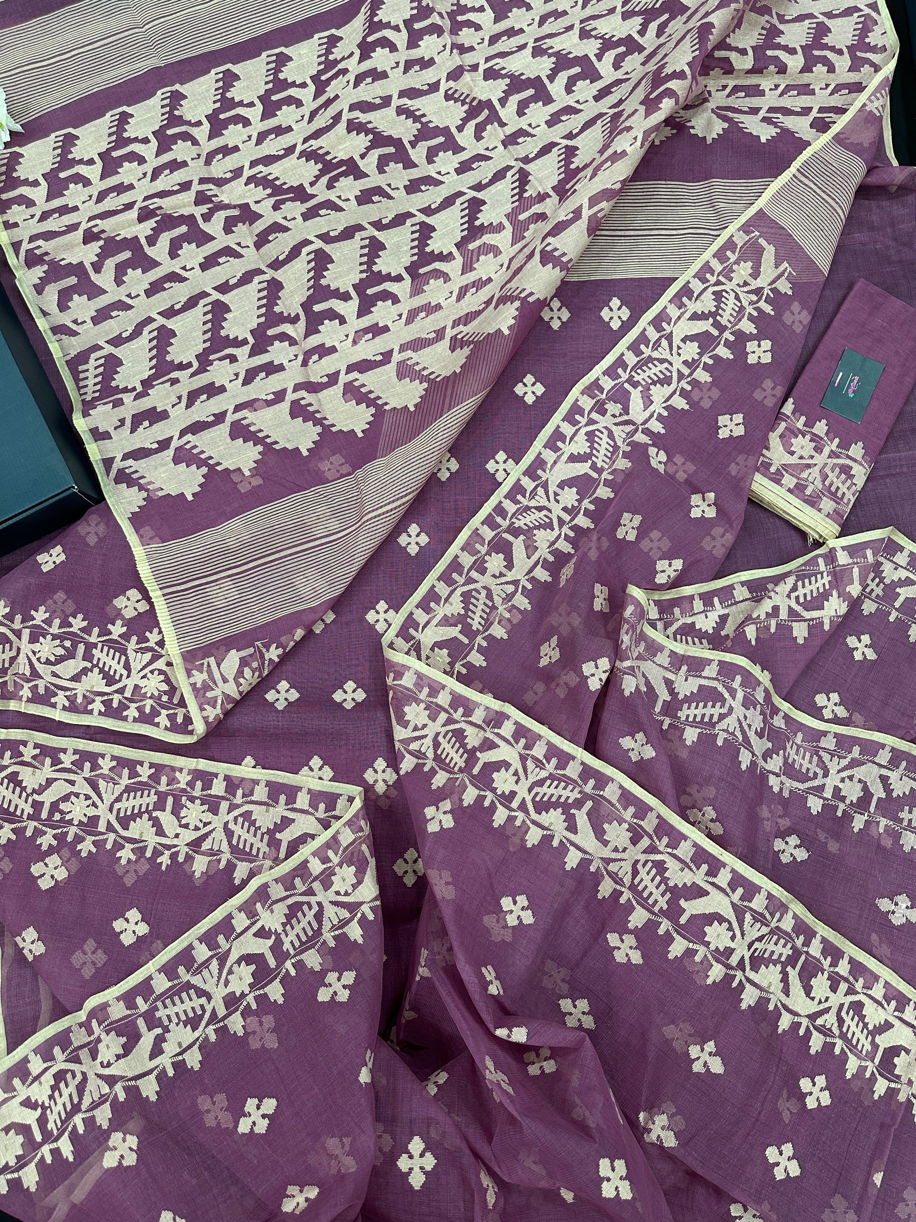 Onion cotton jamdani saree with yellowish threads work all over work.