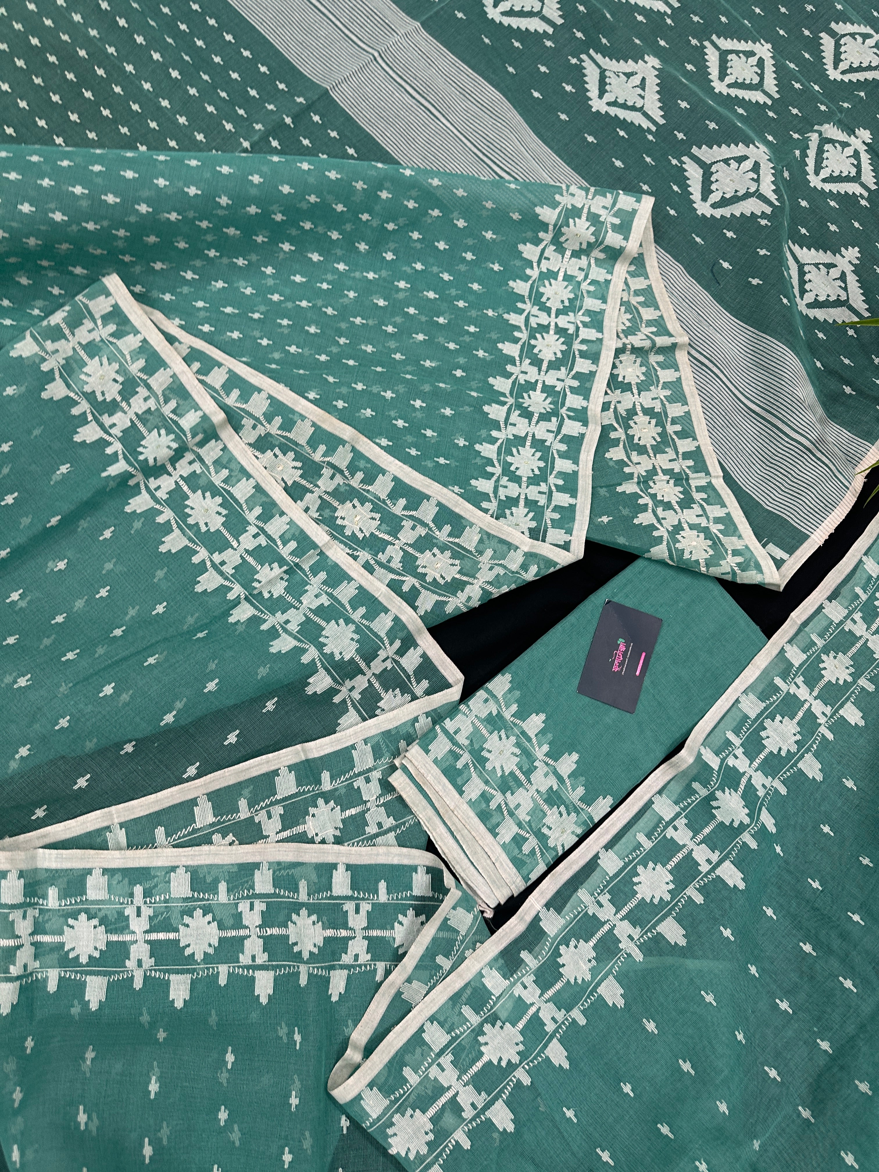 Mint cotton jamdani saree with white threads work all over work and blouse piece.