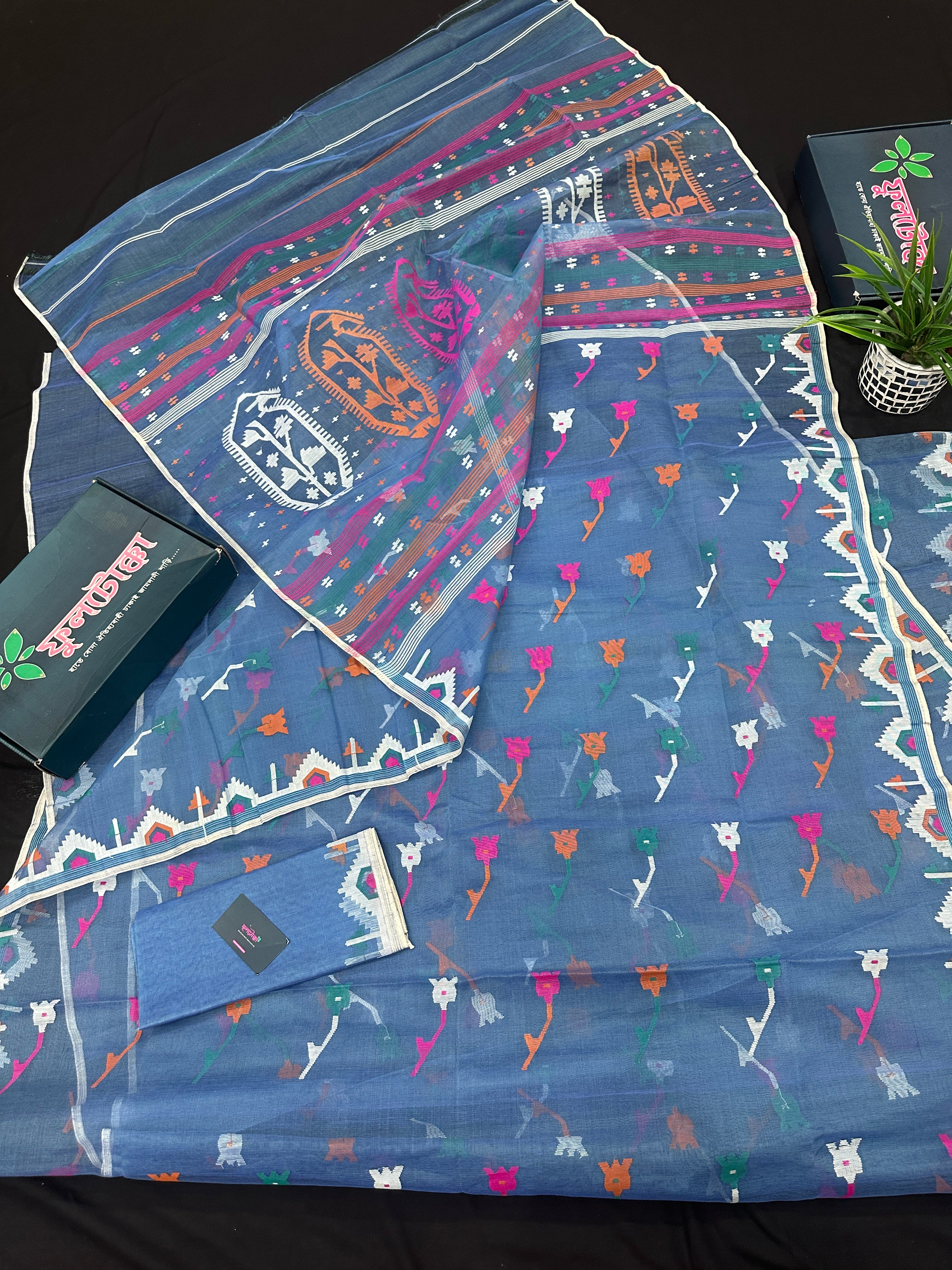 Dusty blue jamdani saree with pink white blue green work and white paar.