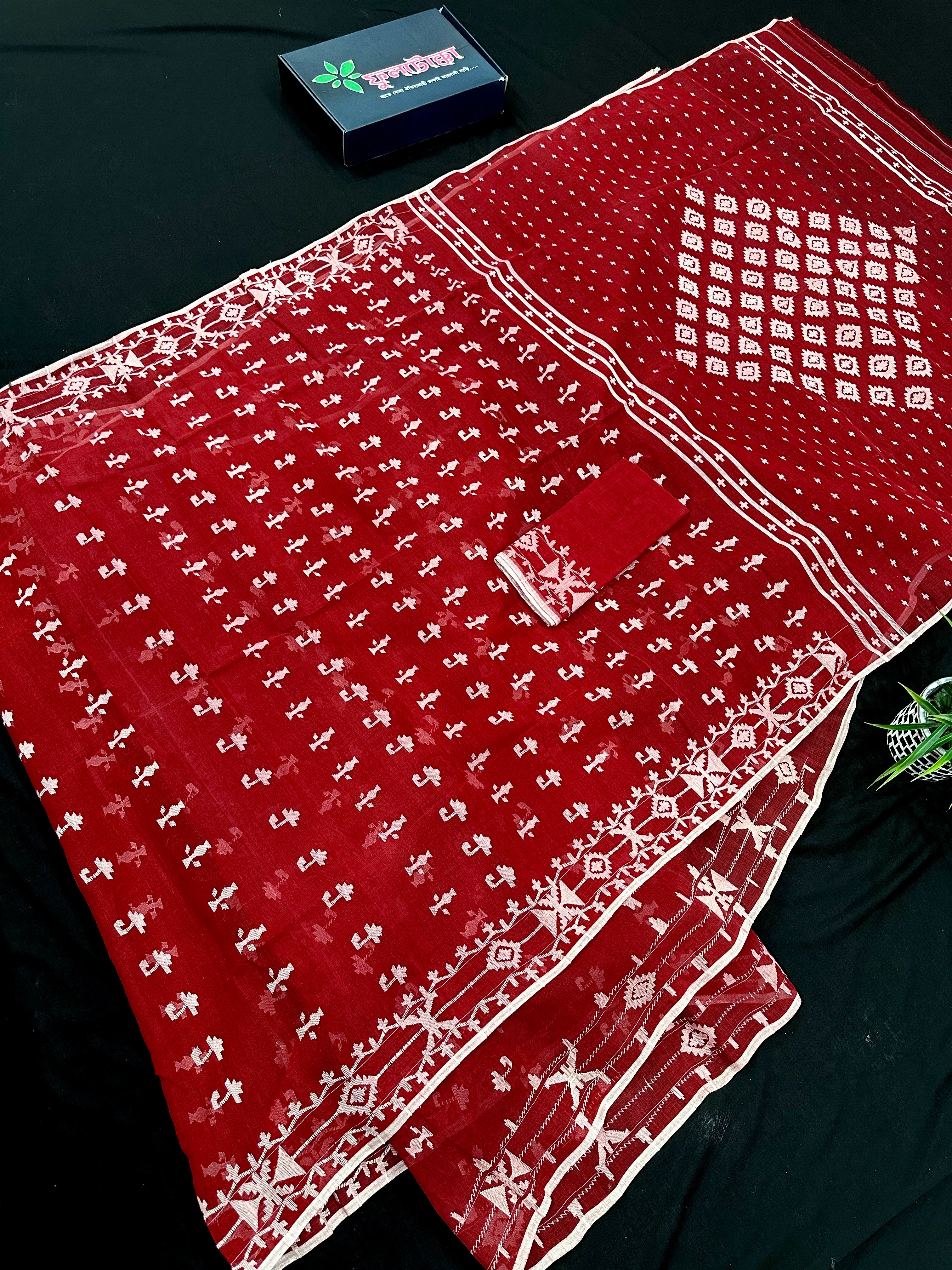 Maroon jamdani saree with white thread work.