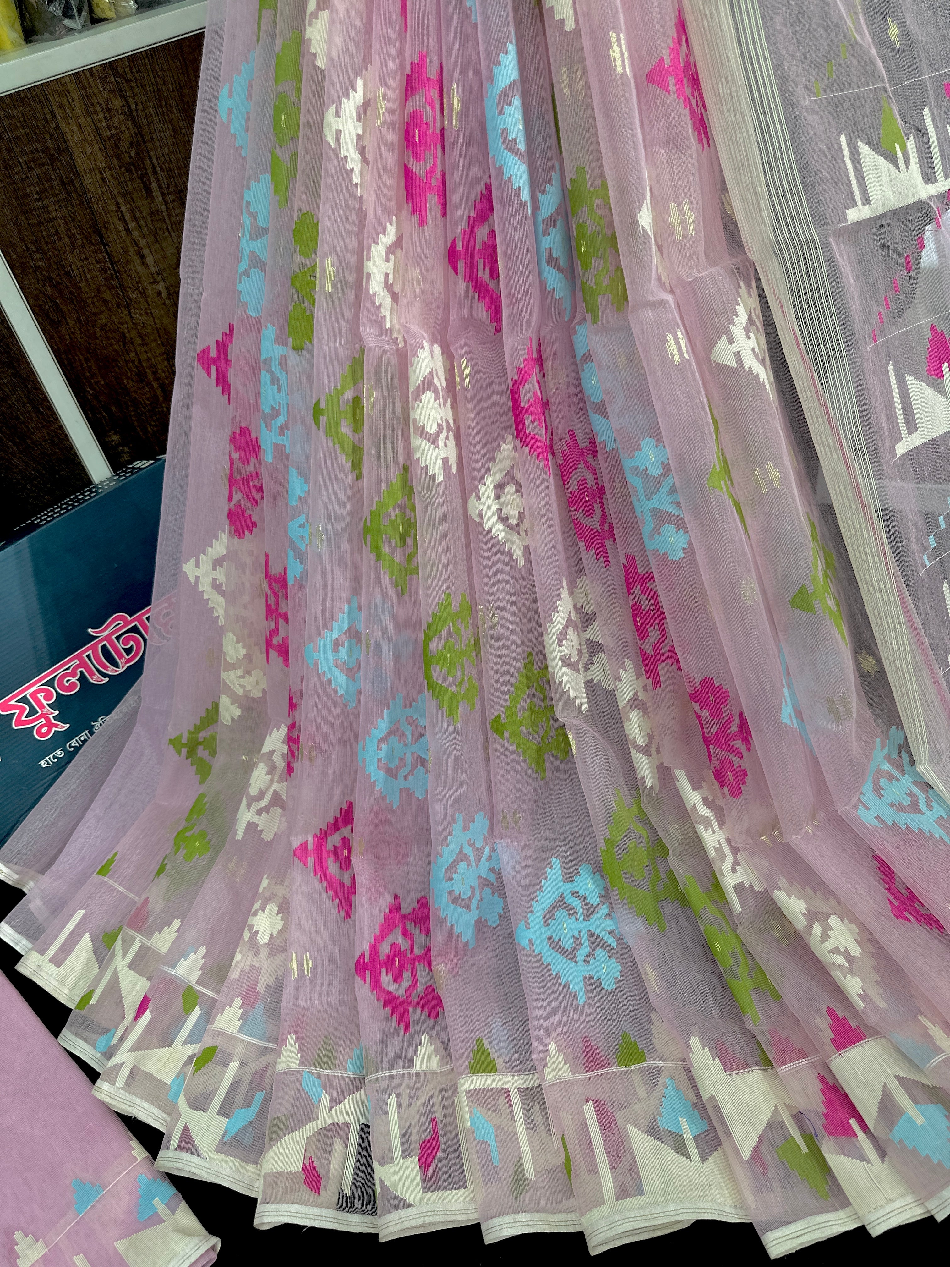 Baby pink halfsilk jamdani saree with blue magenta green off white threads work