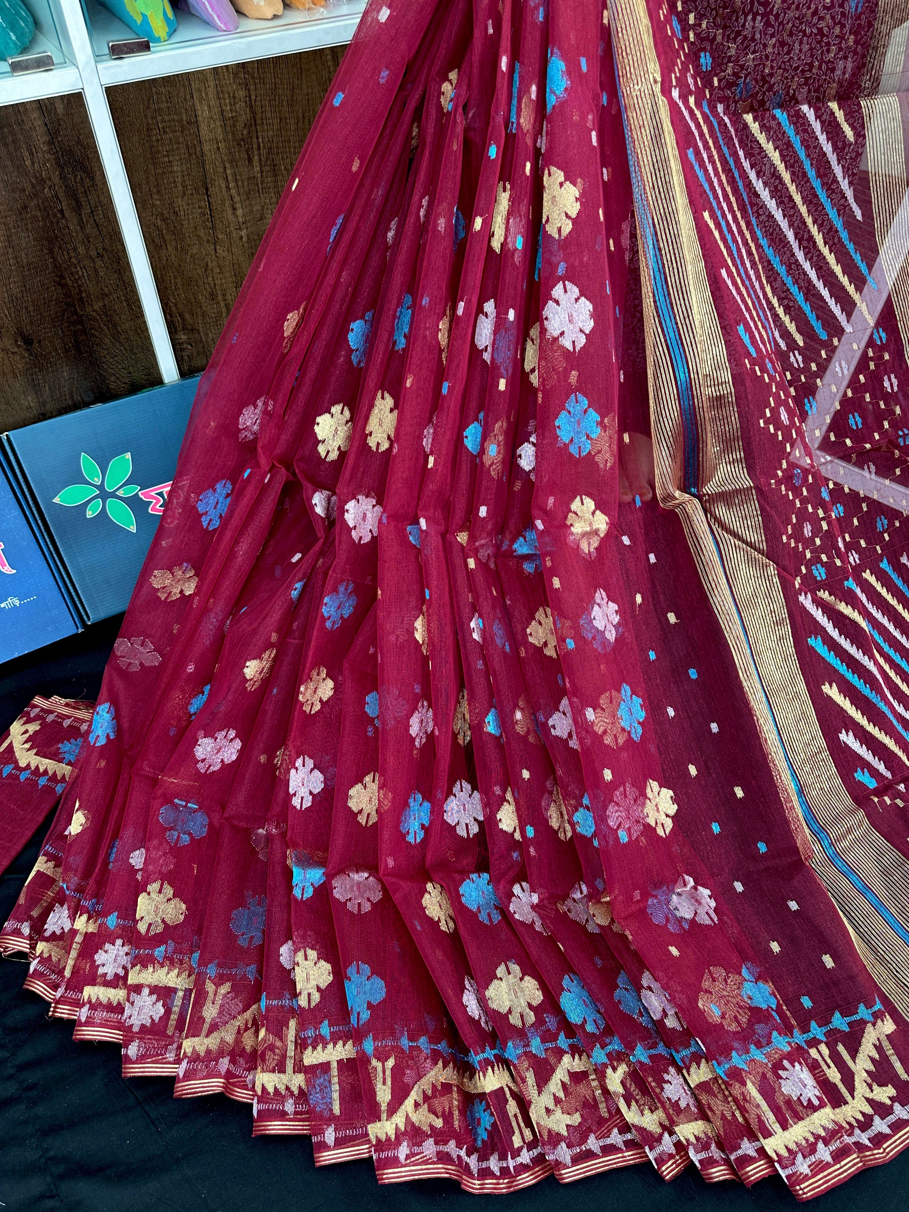Maroon jamdani saree with golden jori work all over work with blouse piece.