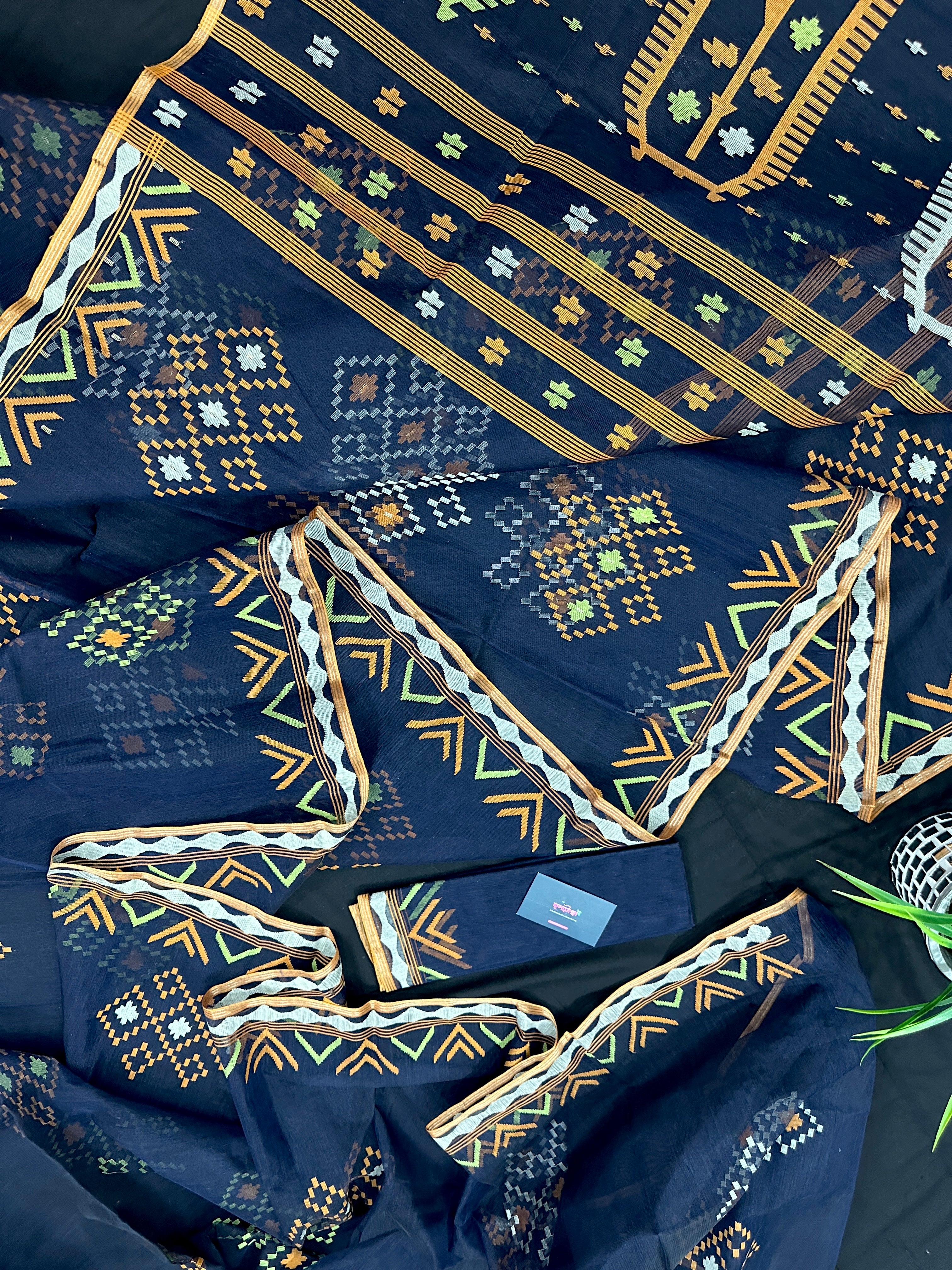 Navy blue jamdani saree with orange  green & off white threads work.