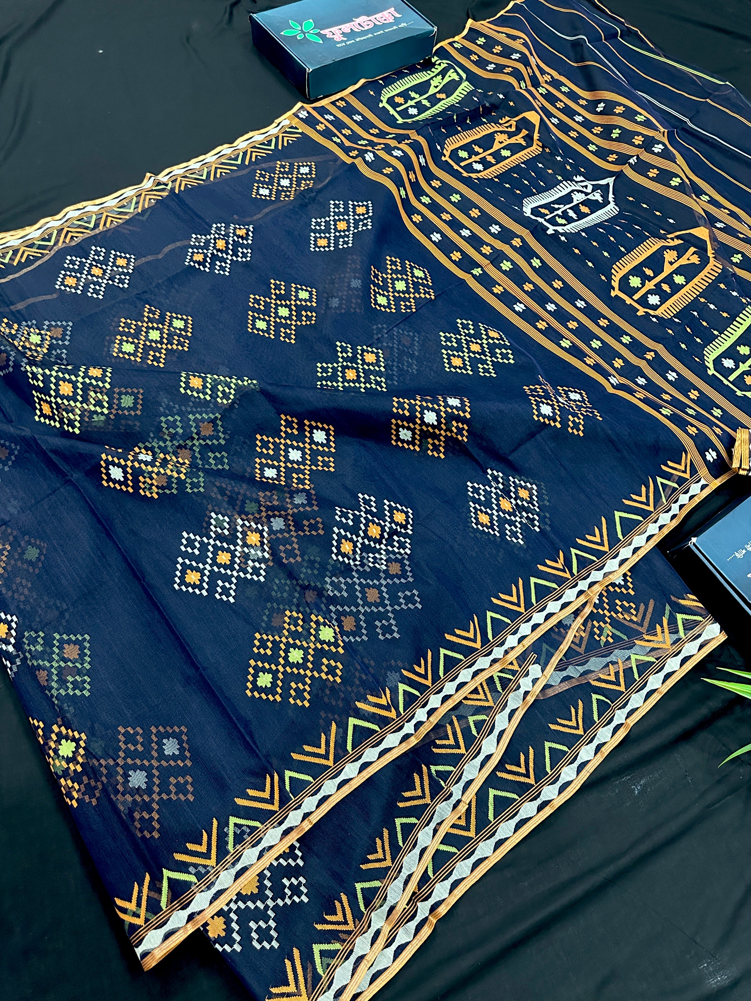 Navy blue jamdani saree with orange  green & off white threads work.