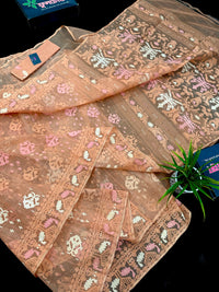 Creamy peach jamdani saree with pink white and peach threads work.
