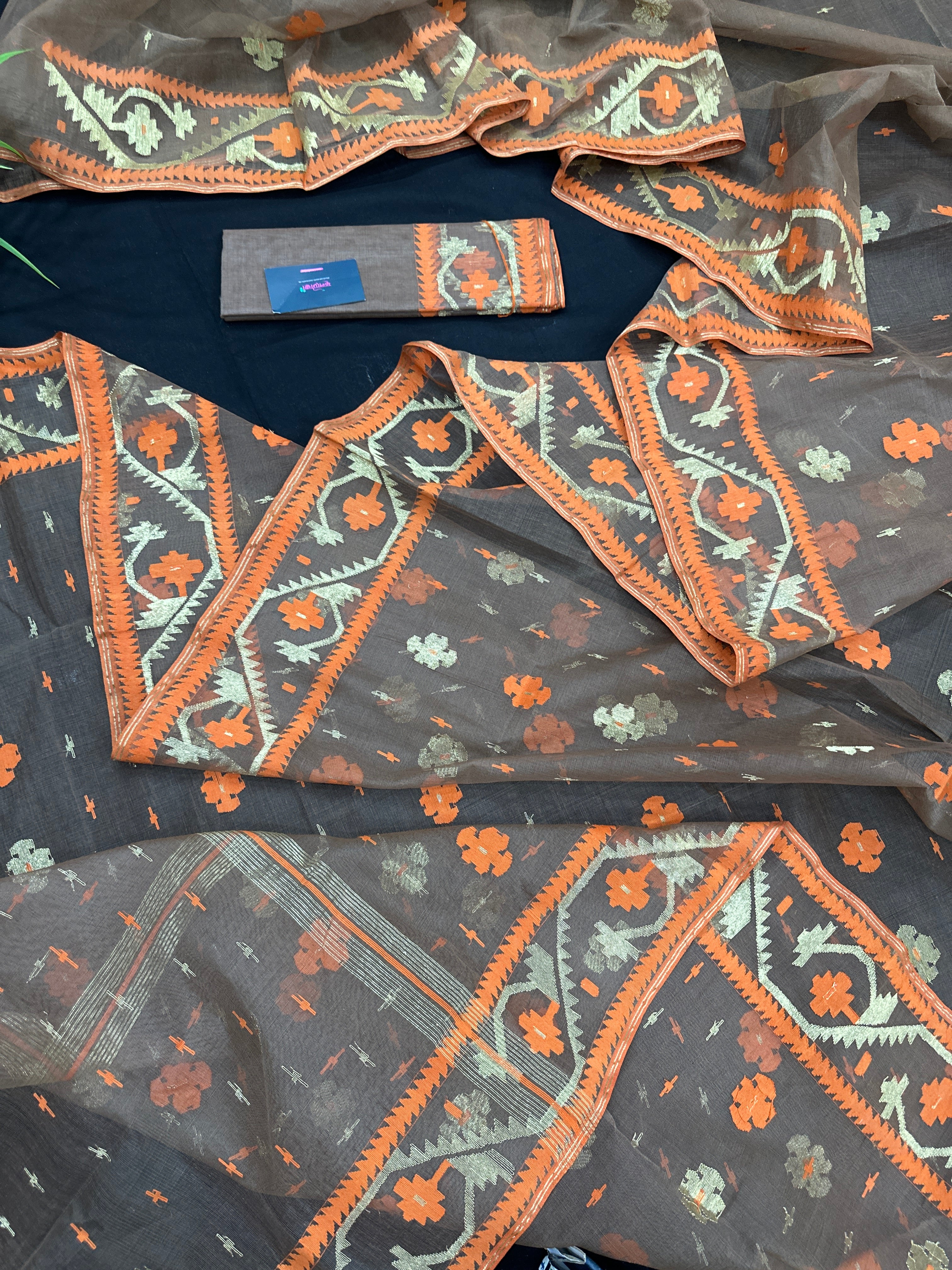 Peanut Brown dhakai jamdani saree with orange threads work & golden jori work all over soft count.