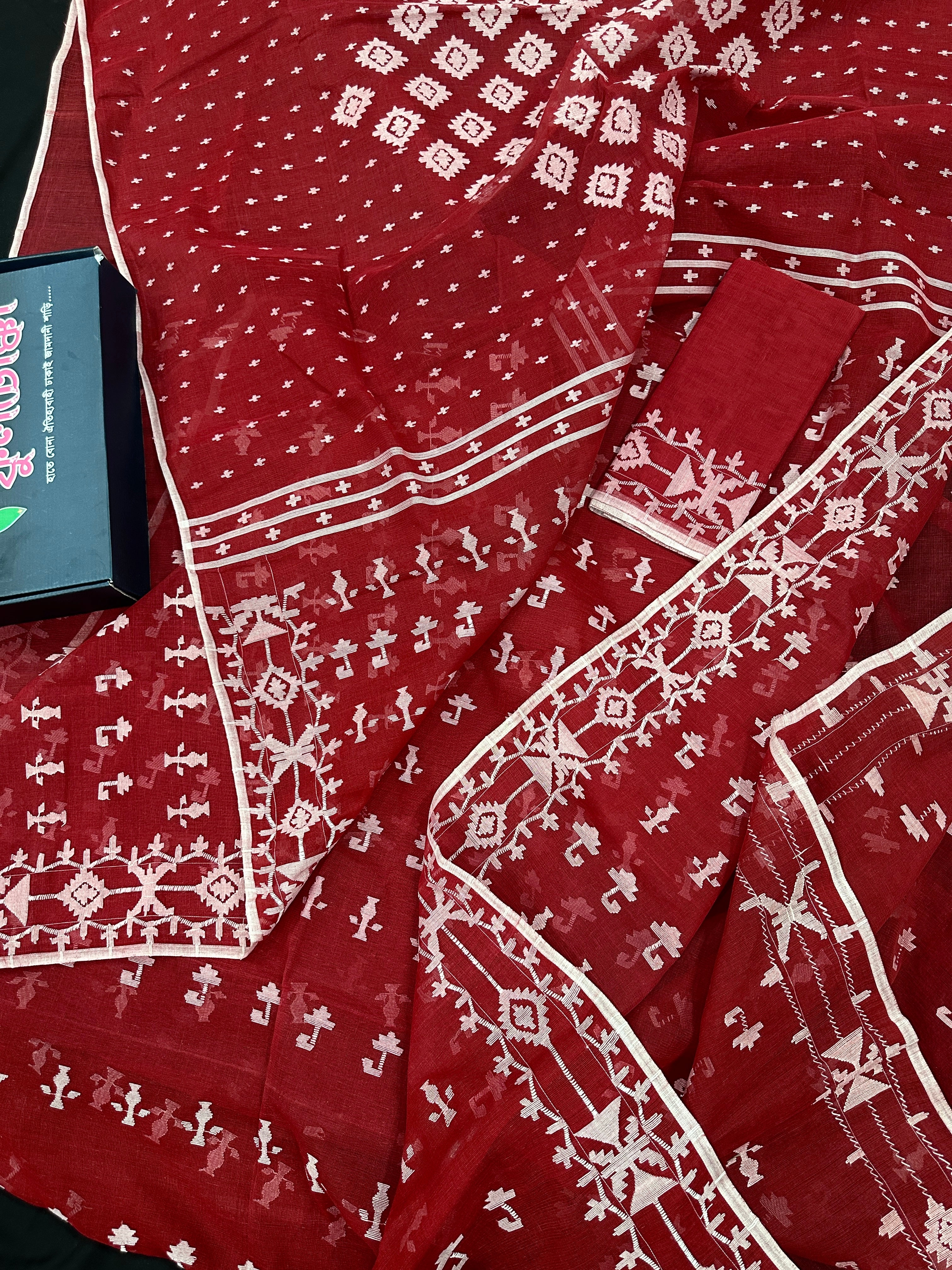 Maroon jamdani saree with white thread work.