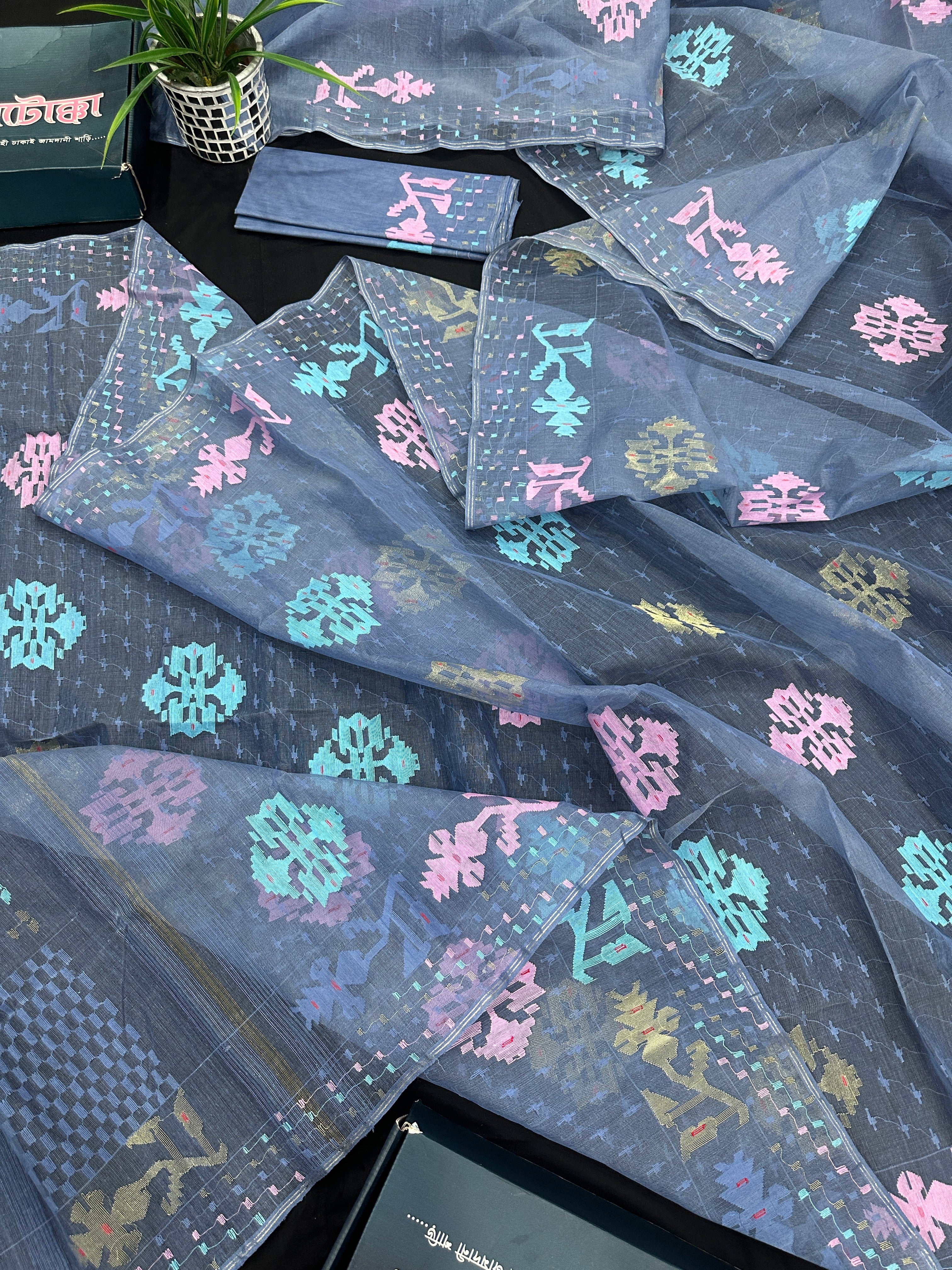 Powdery blue jamdani saree with pink blue and golden jori work.