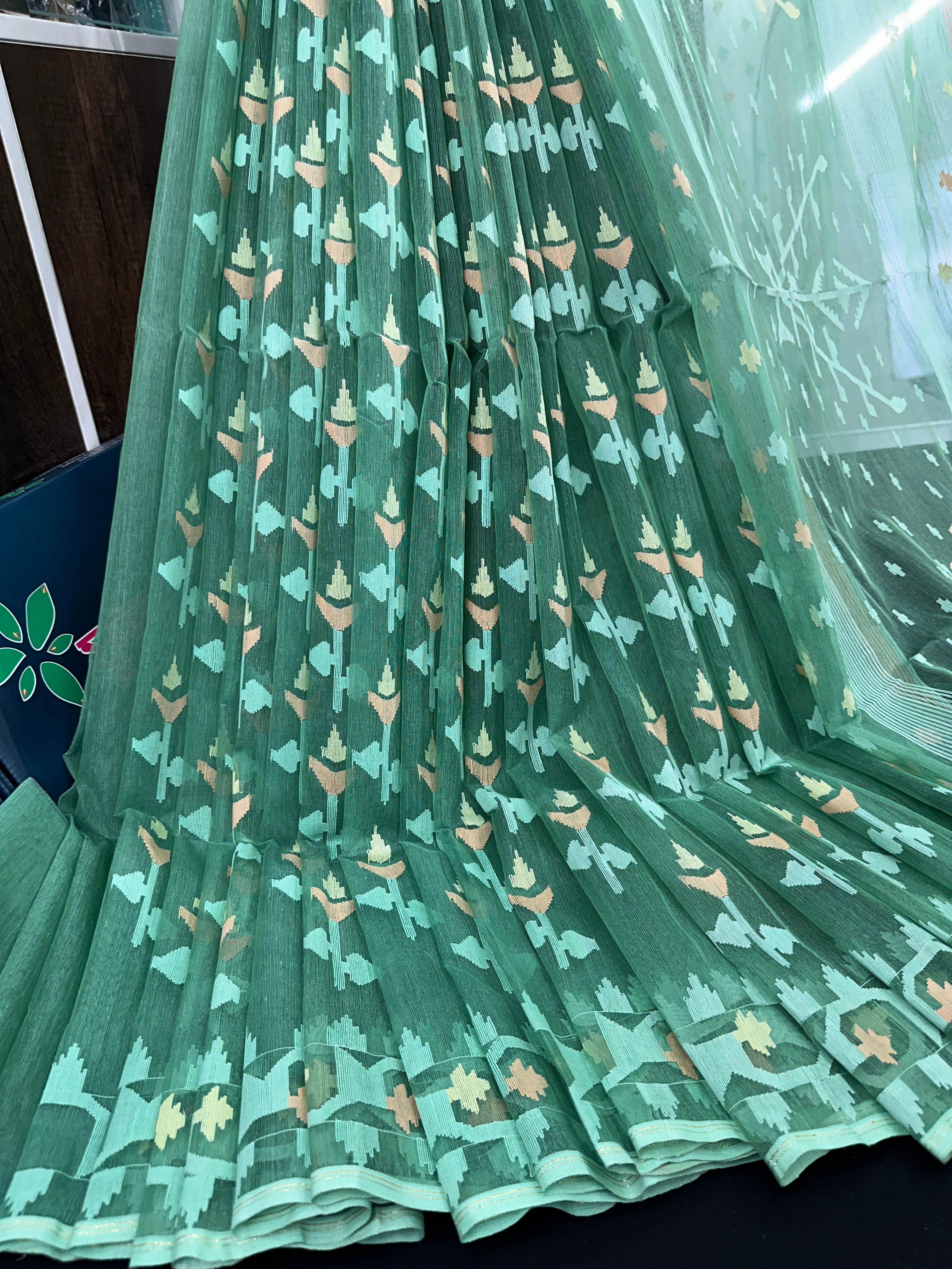 Jade green halfsilk jamdani saree with green off white golden self threads work