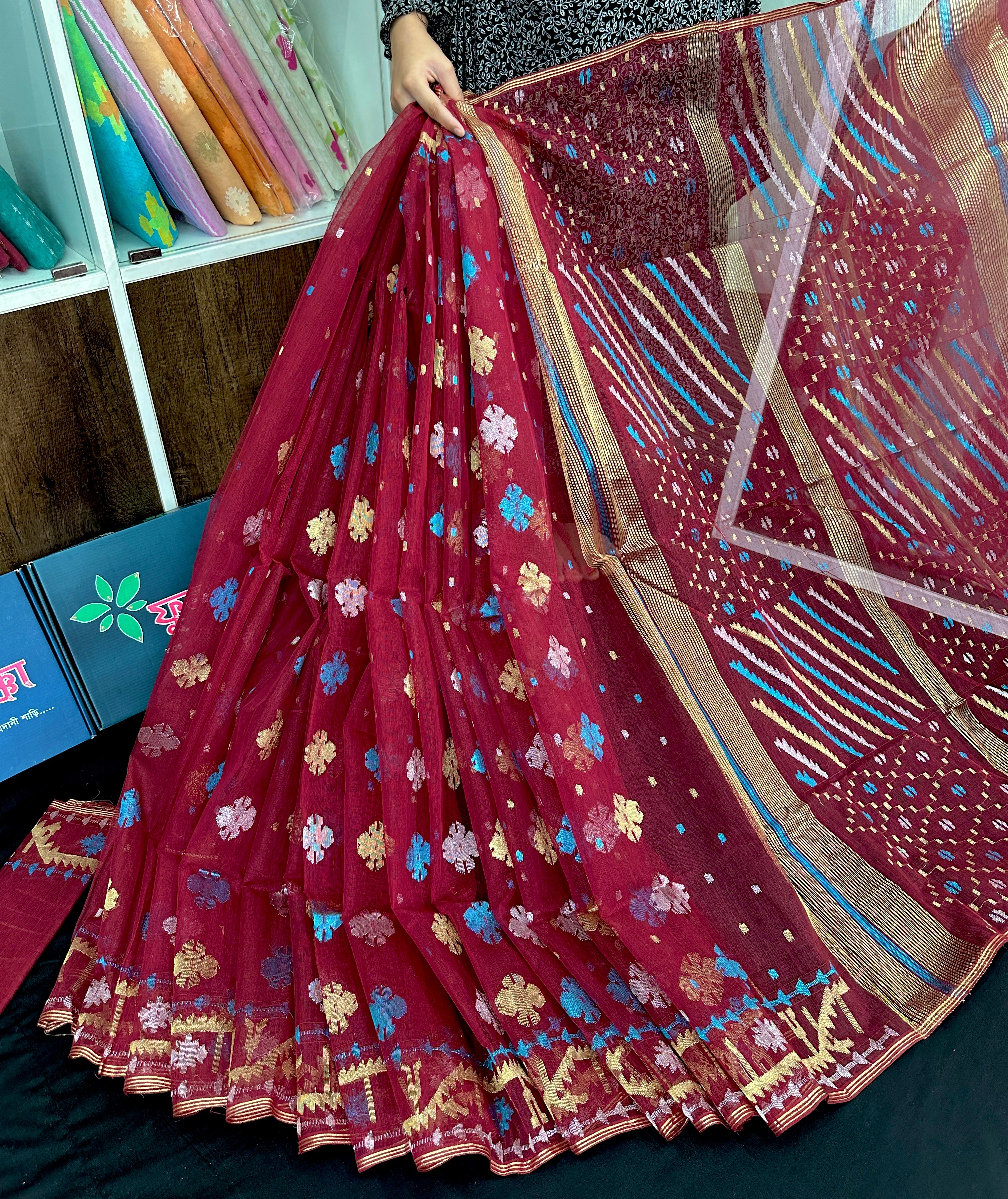 Maroon jamdani saree with golden jori work all over work with blouse piece.