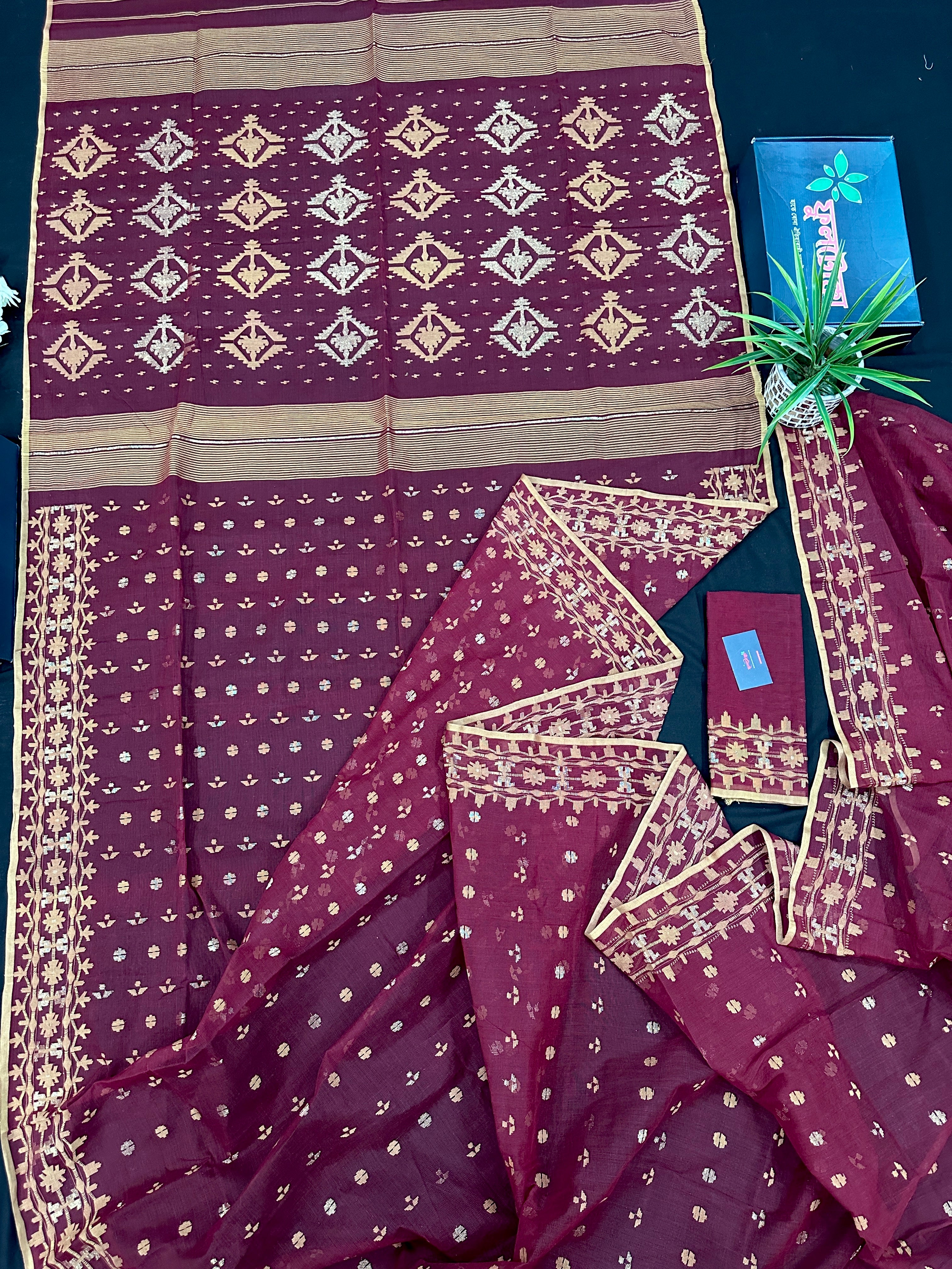 Maroon cotton jamdani with yellowish threads work.