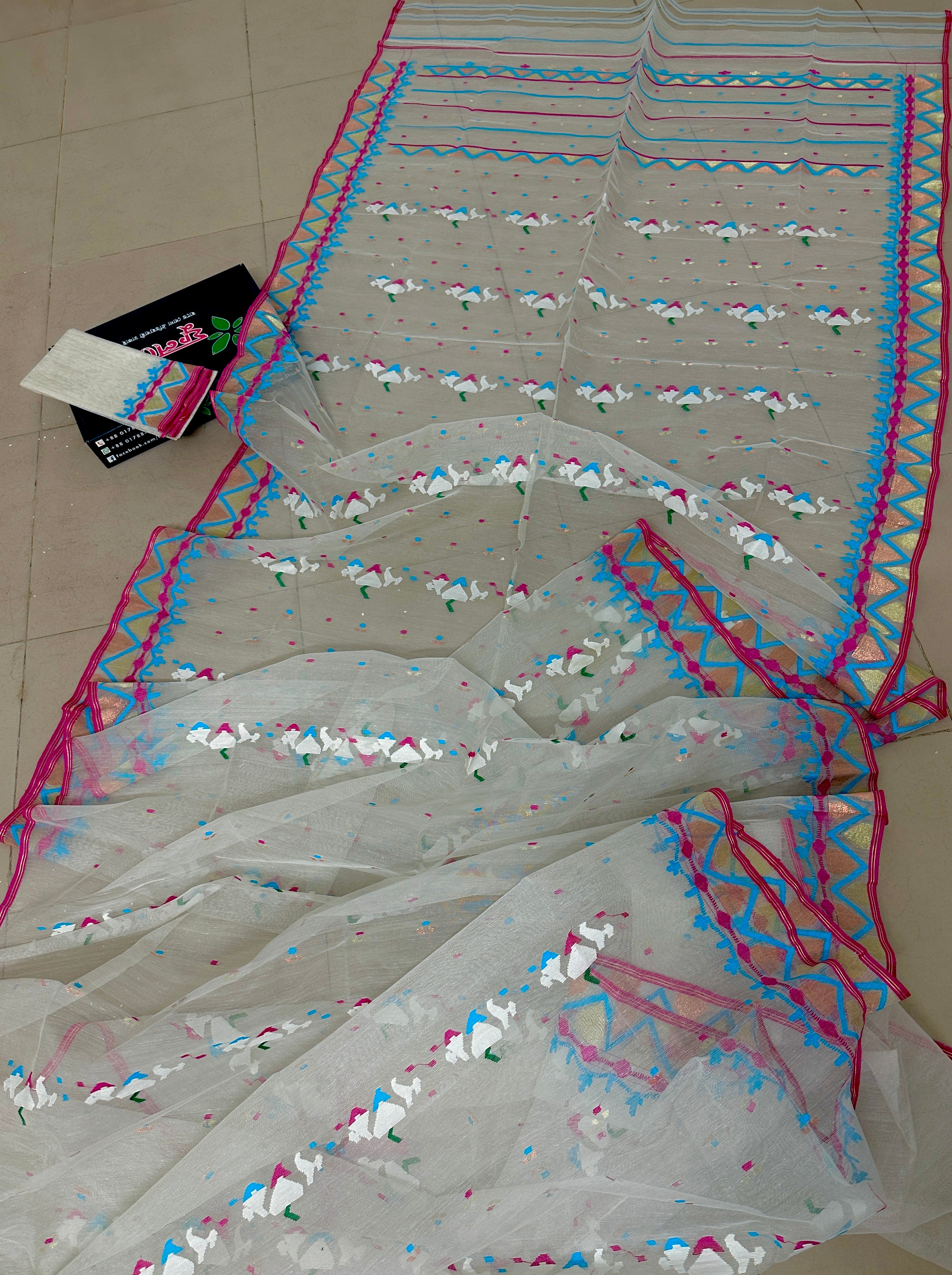 White jamdani with pink border.