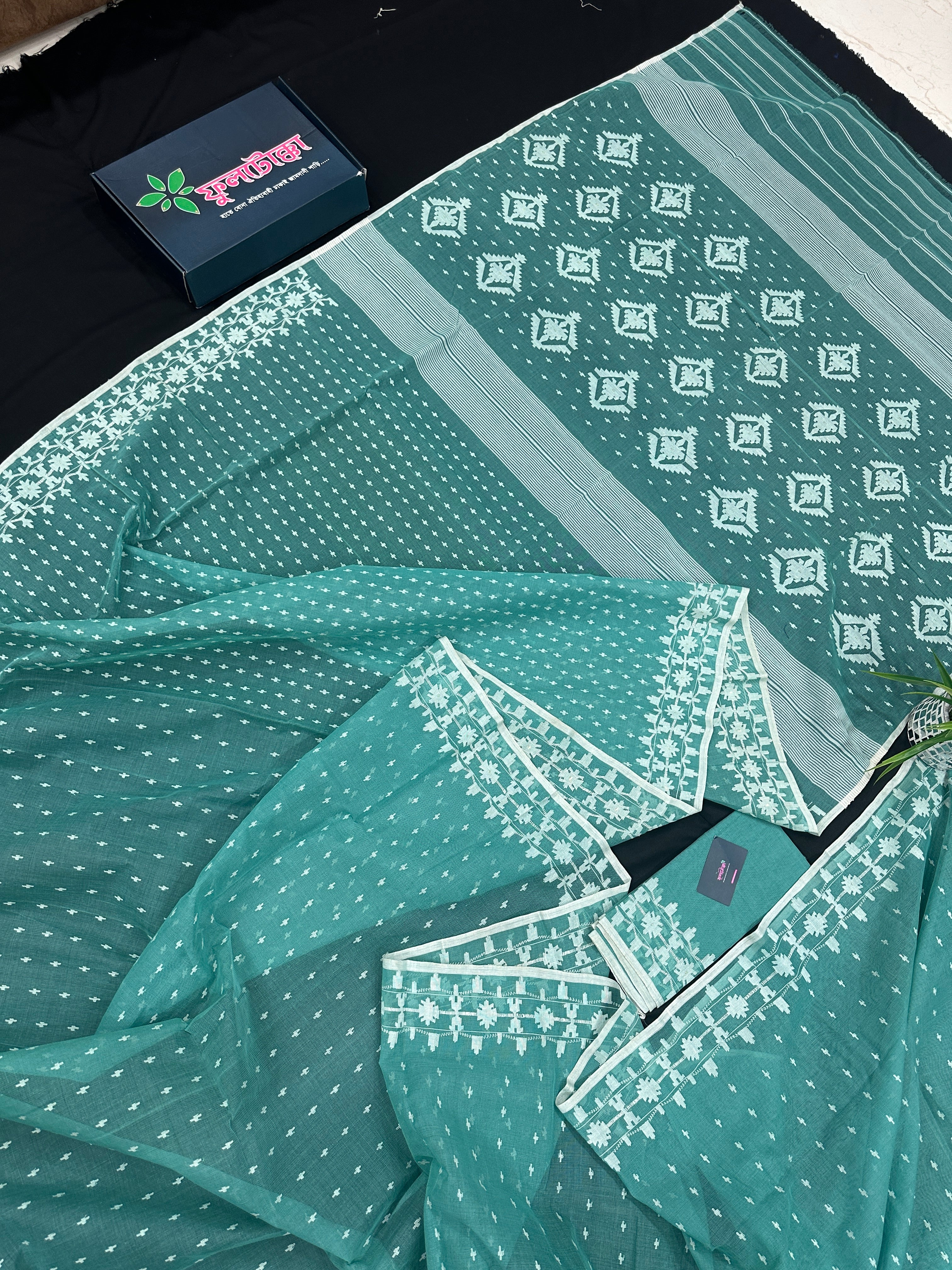 Mint cotton jamdani saree with white threads work all over work and blouse piece.