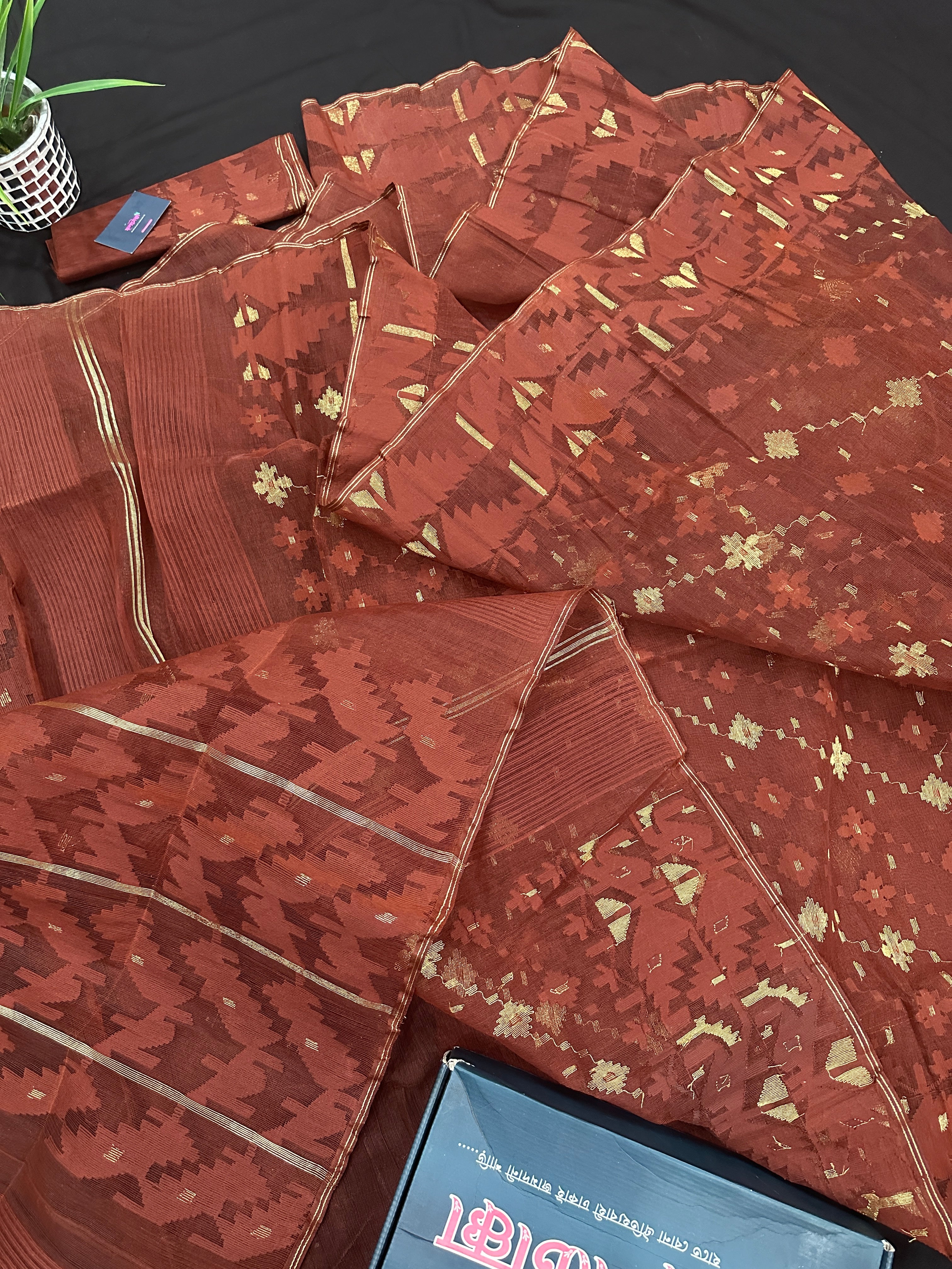 Mehendi brown jamdani saree with golden work.