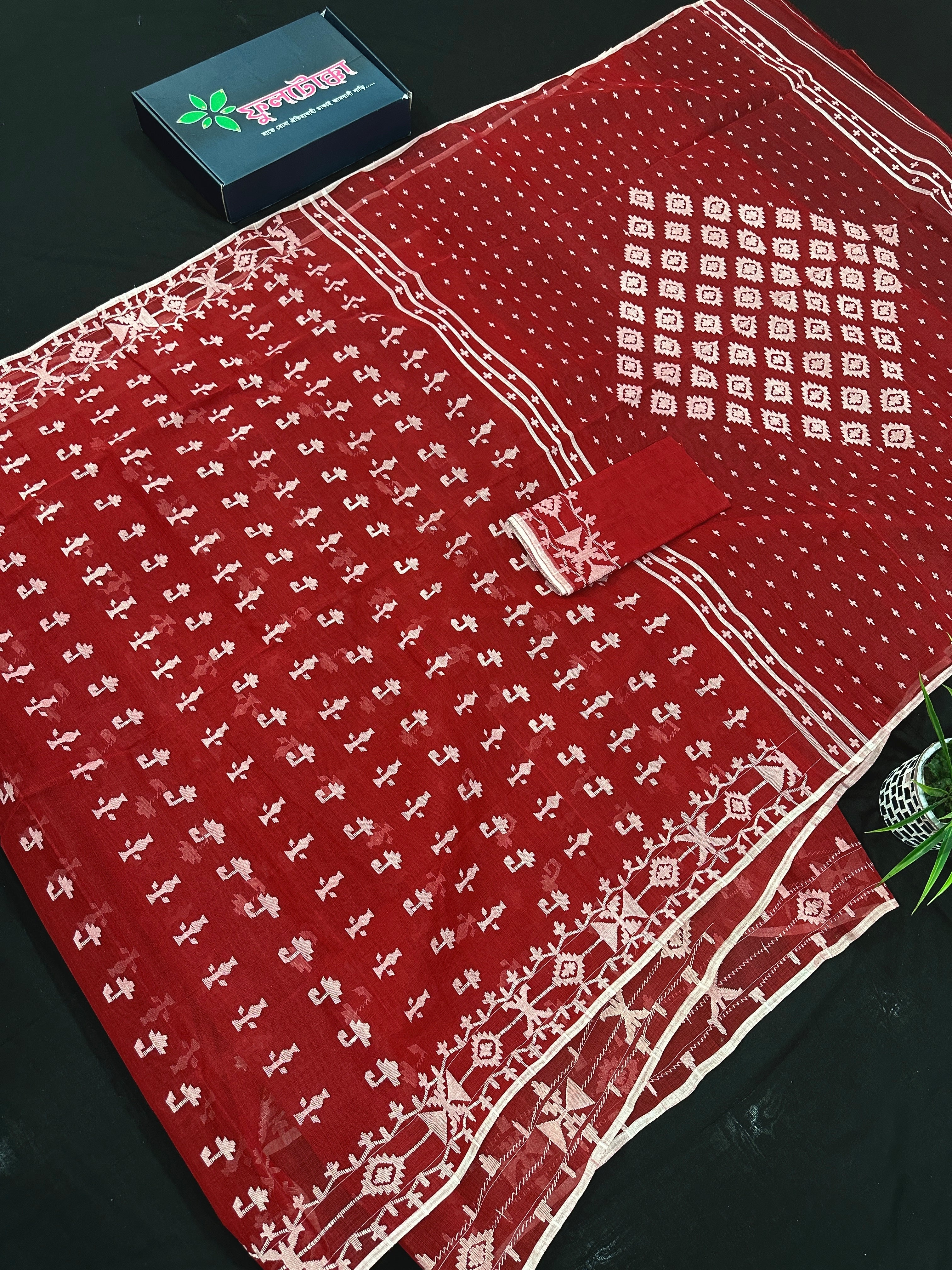 Maroon jamdani saree with white thread work.