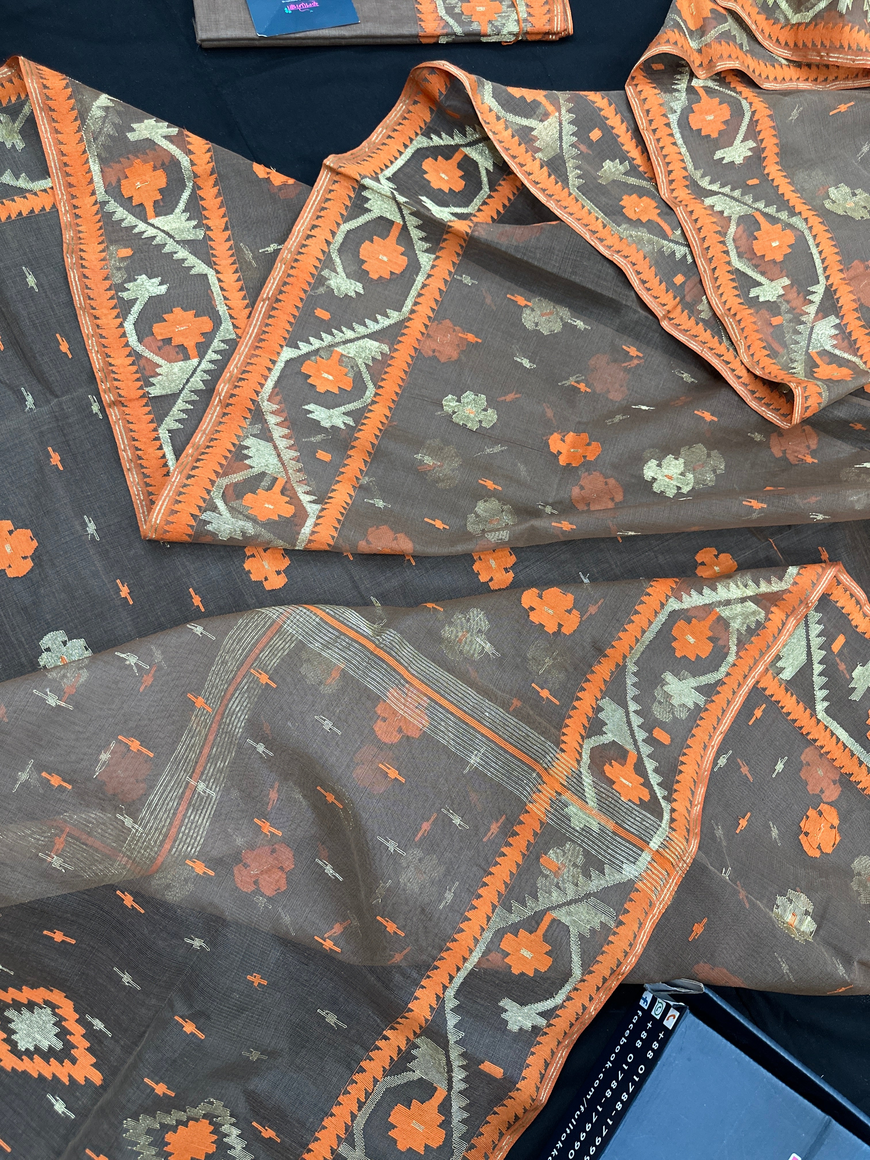 Peanut Brown dhakai jamdani saree with orange threads work & golden jori work all over soft count.