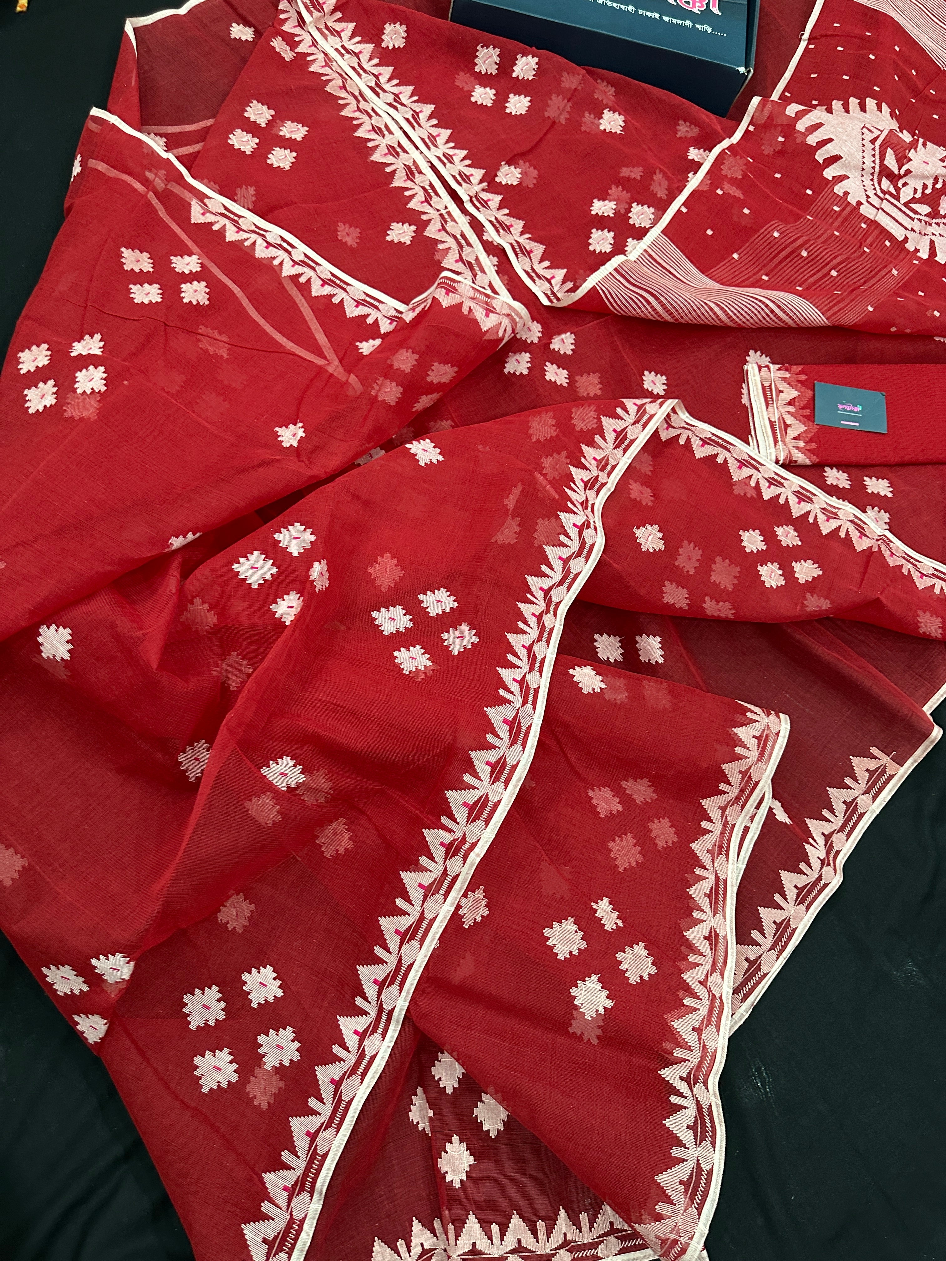 Radish Maroon cotton jamdani saree with white threads work all over work.