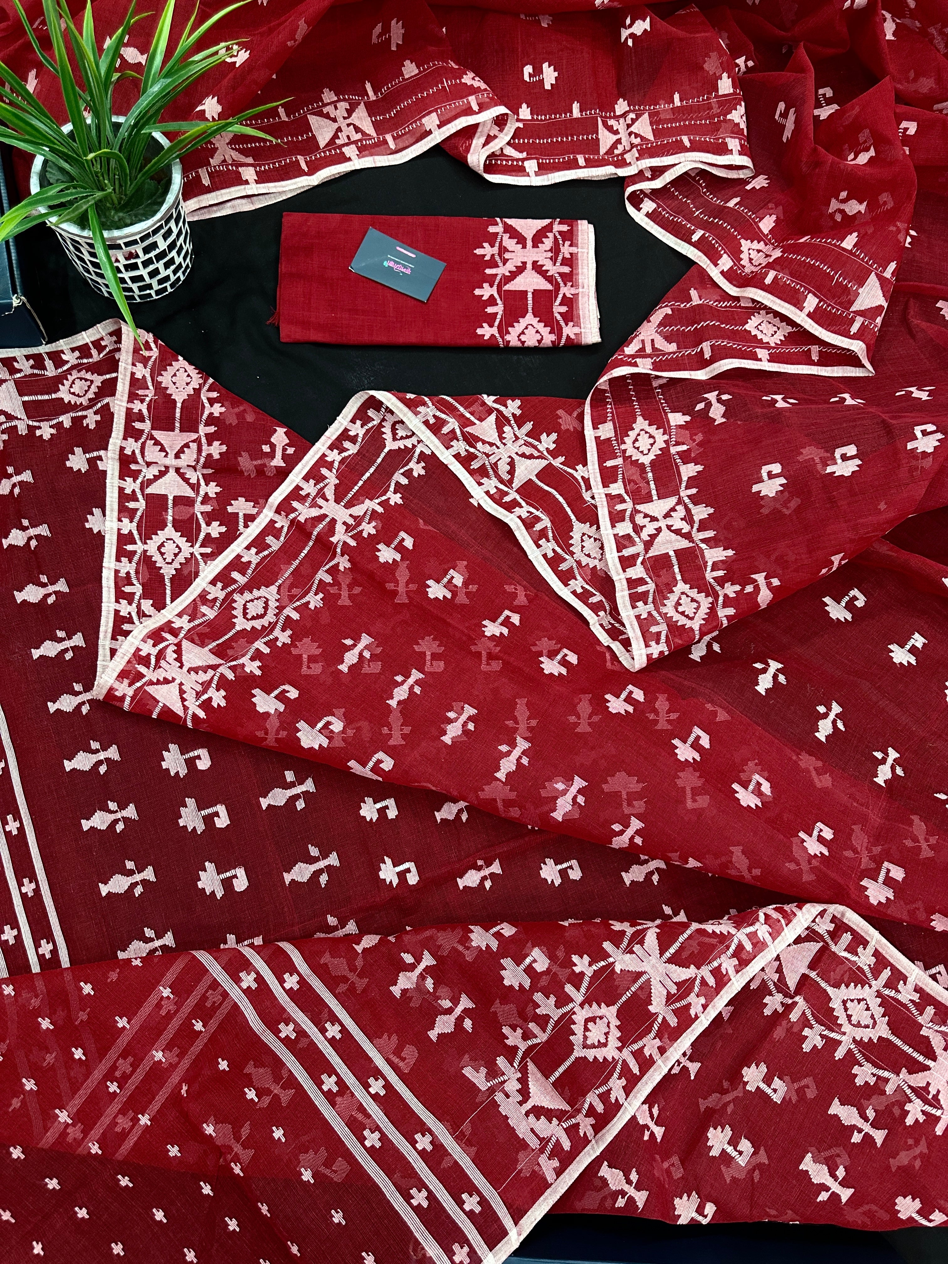 Maroon jamdani saree with white thread work.