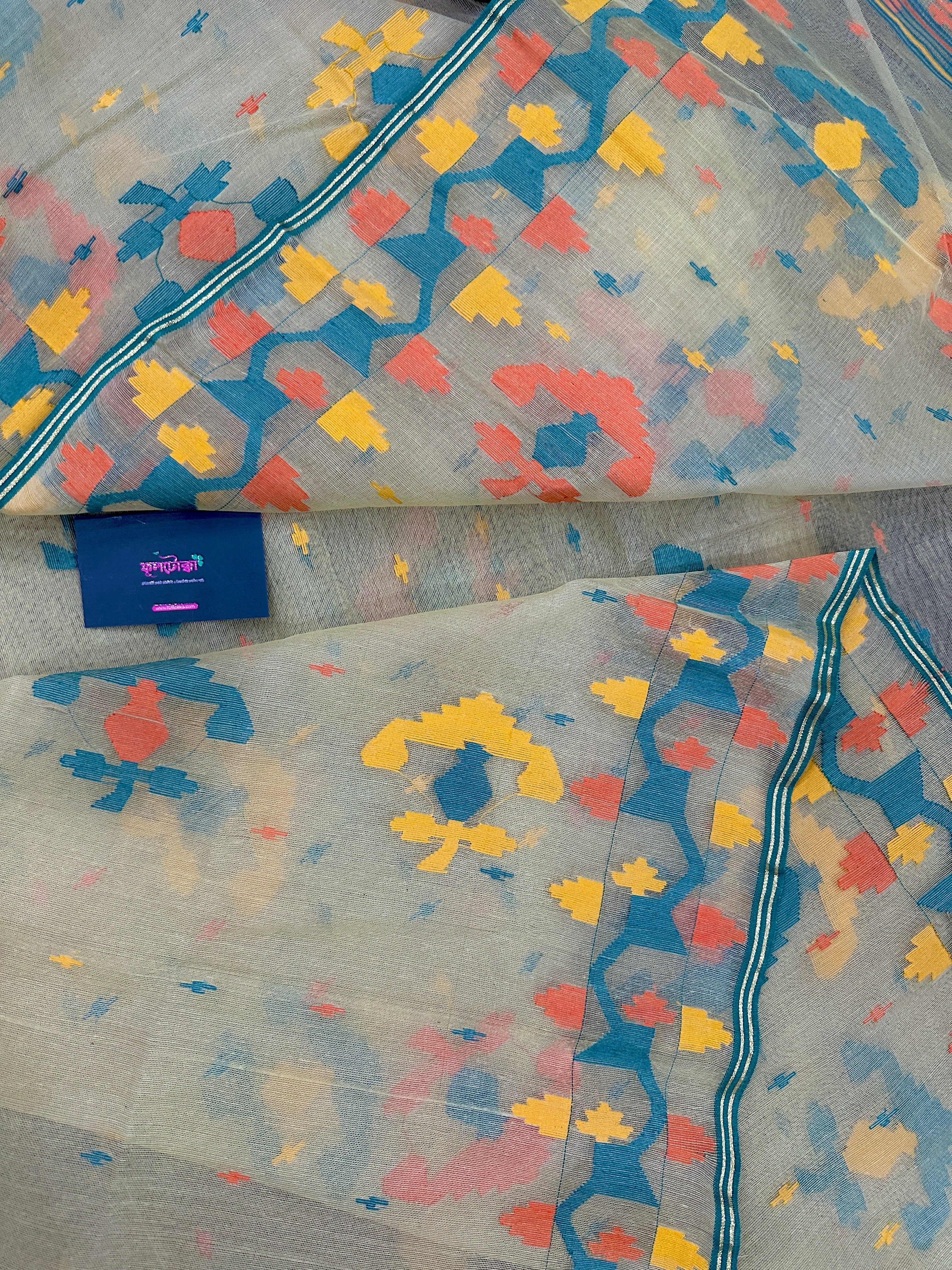 Cream colour jamdani saree with yellow orange blue floral threads work and blouse piece.