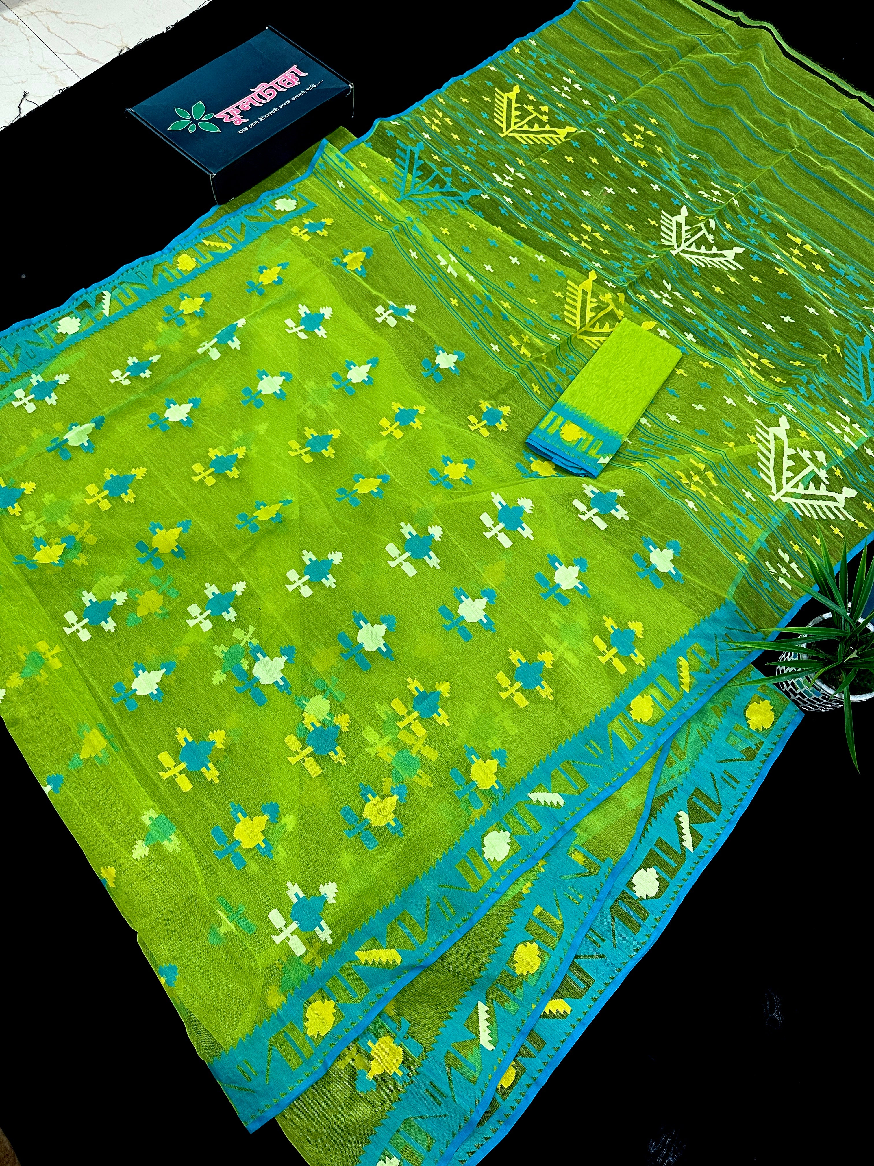 Parrot green jamdani saree with multi colour work with blue Paar.