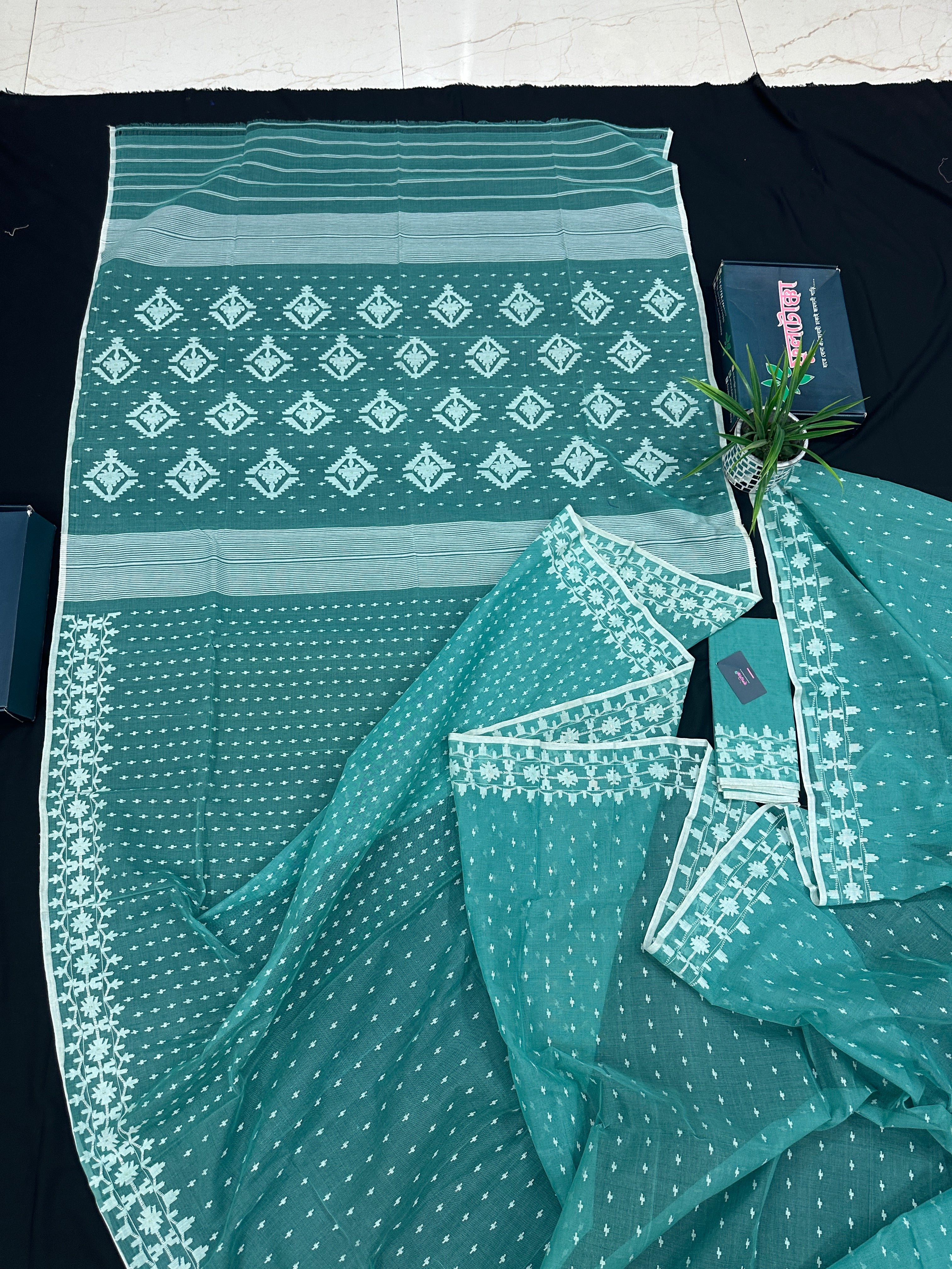 Mint cotton jamdani saree with white threads work all over work and blouse piece.