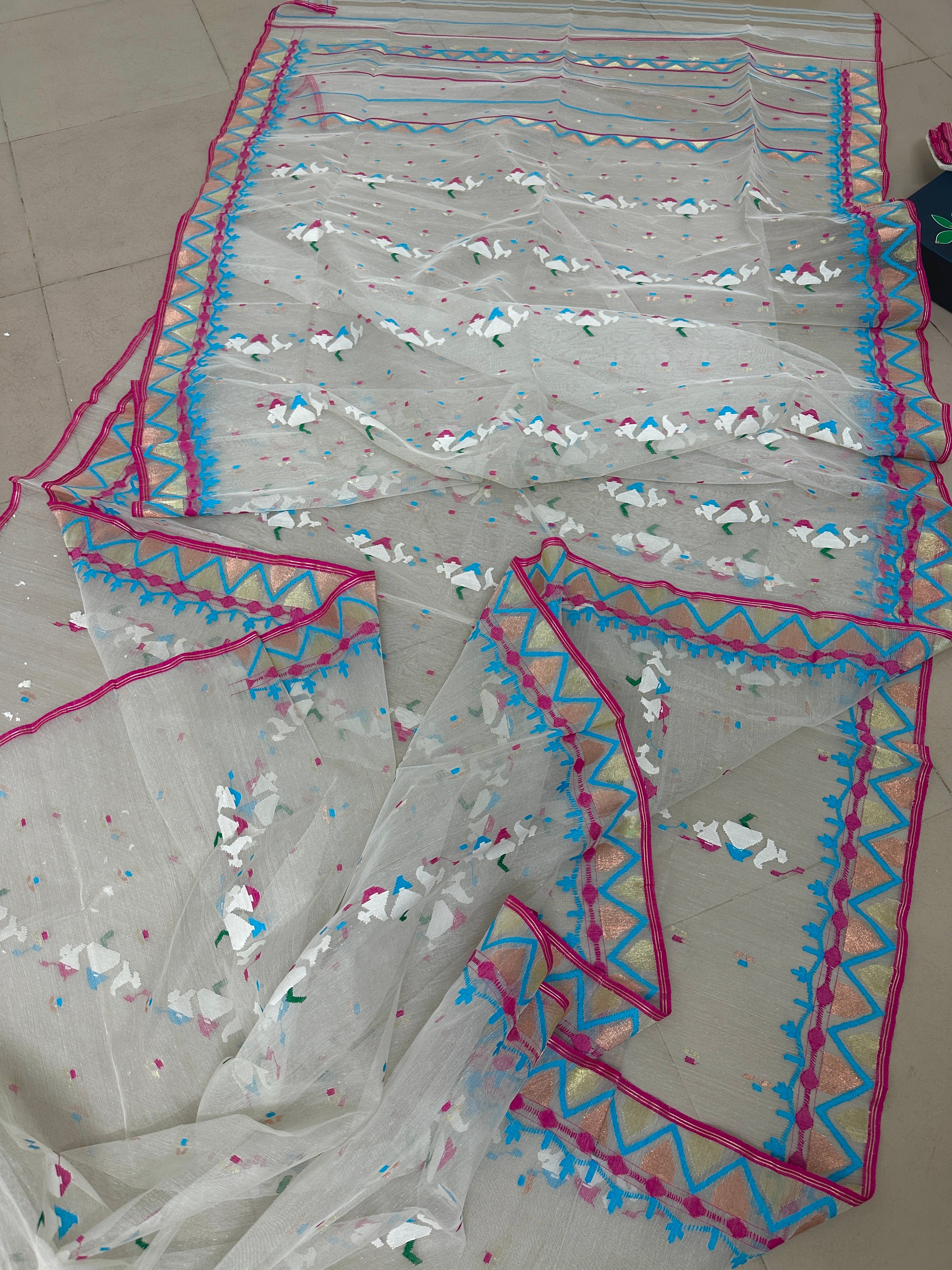 White jamdani with pink border.