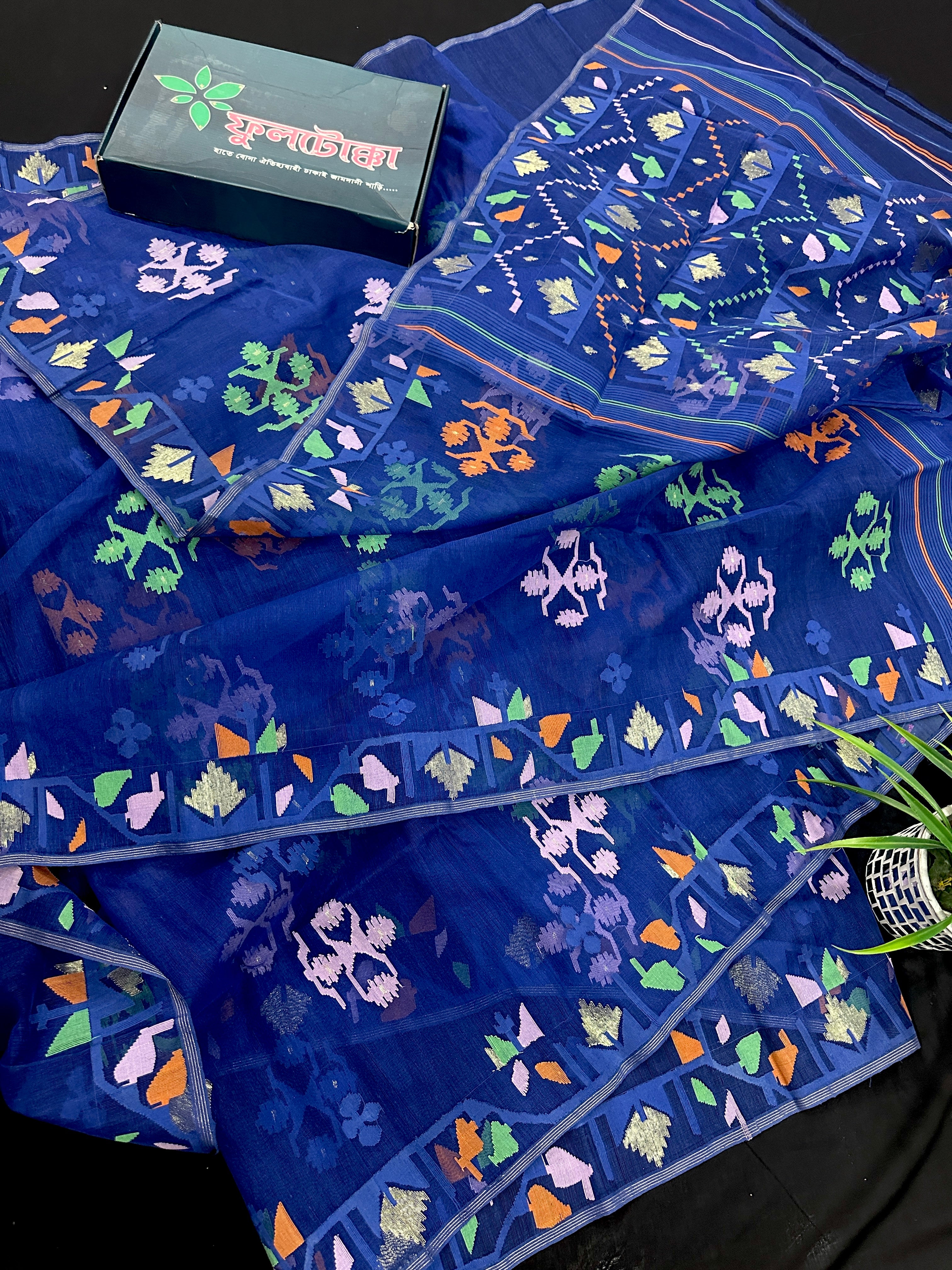Royal blue jamdani saree with green pink blue orange threads work.