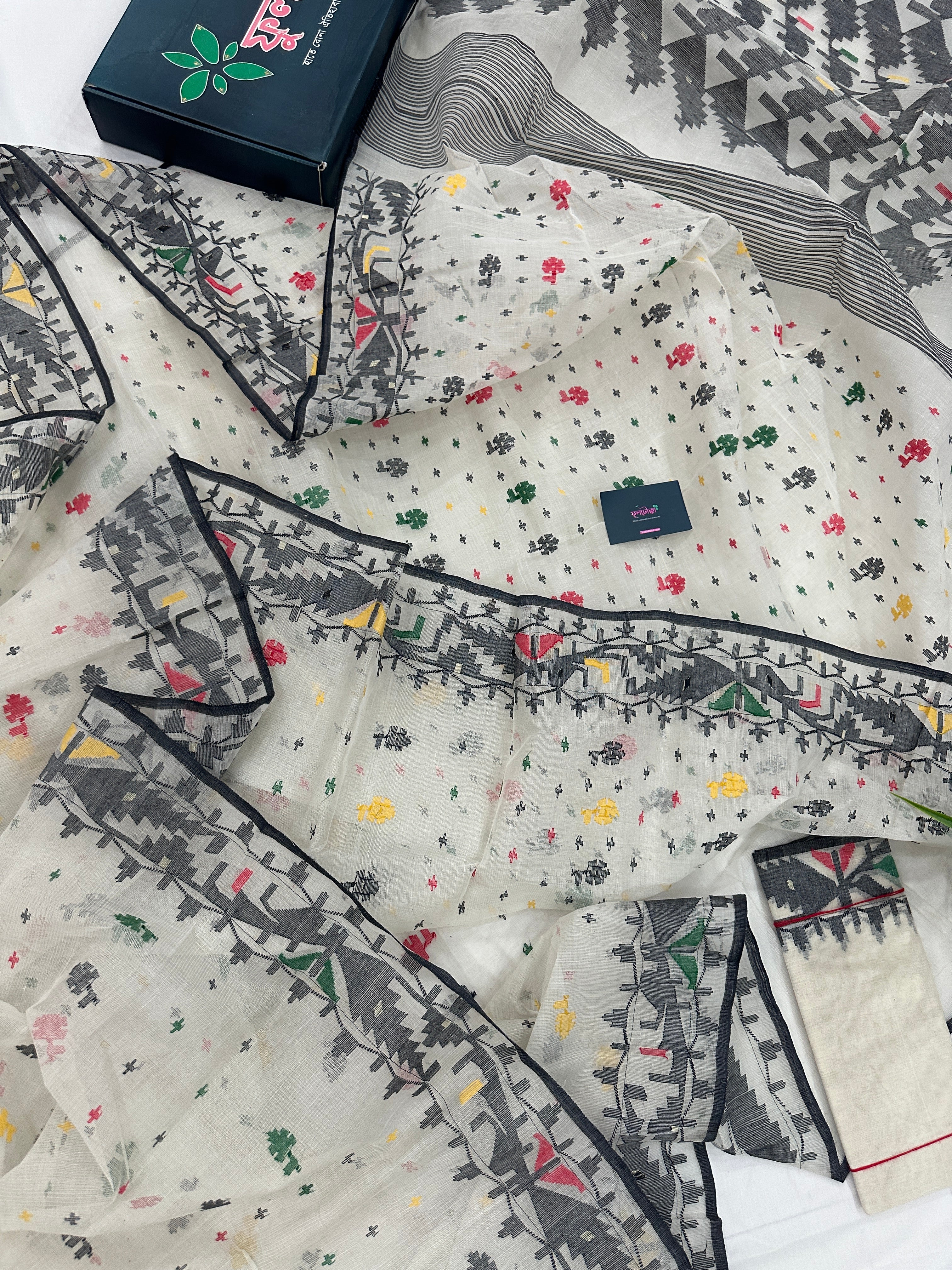 White cotton jamdani saree with black red yellow green threads work & blouse piece.