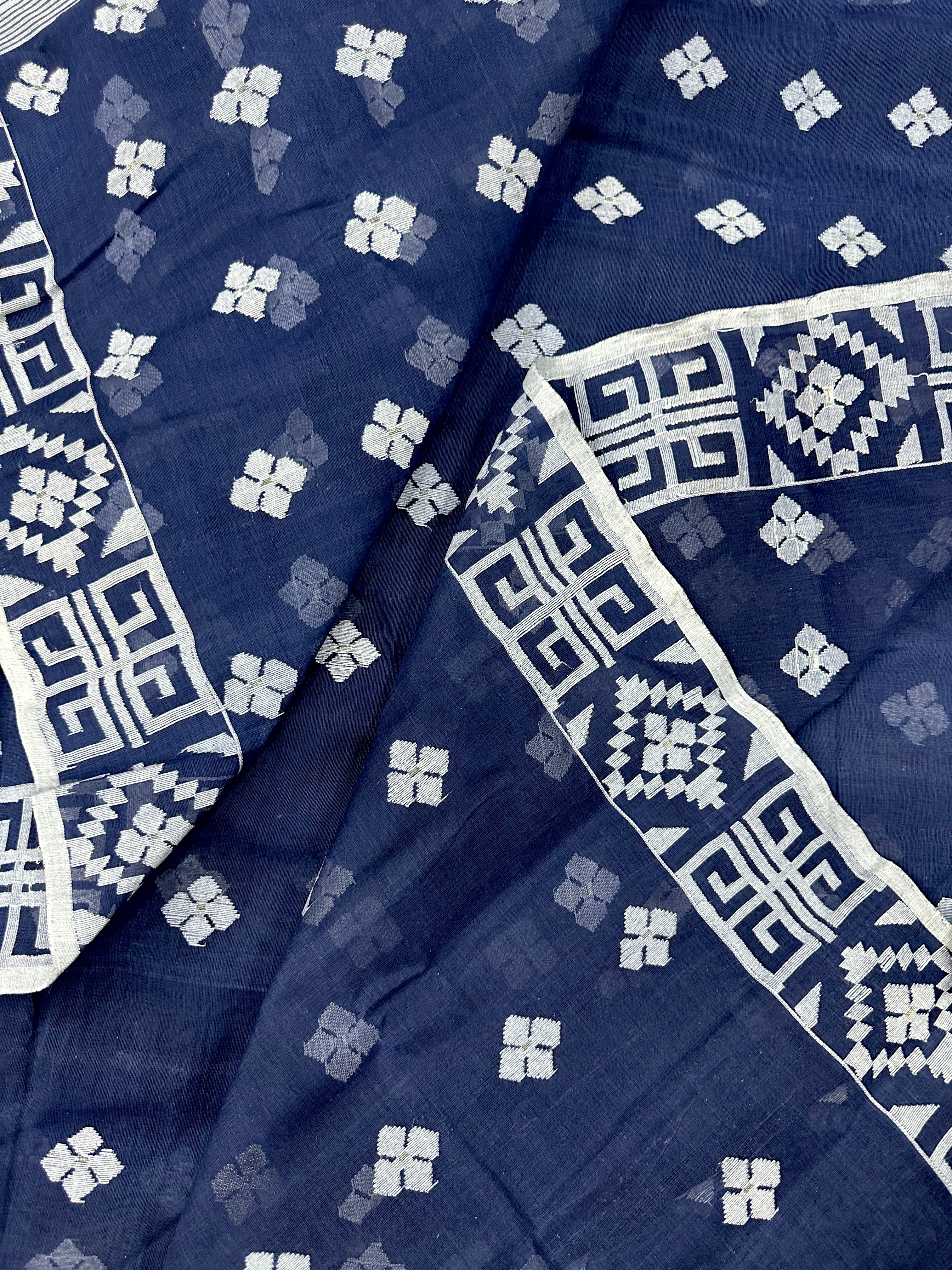 Deep blue jandani saree with white threads all over work.