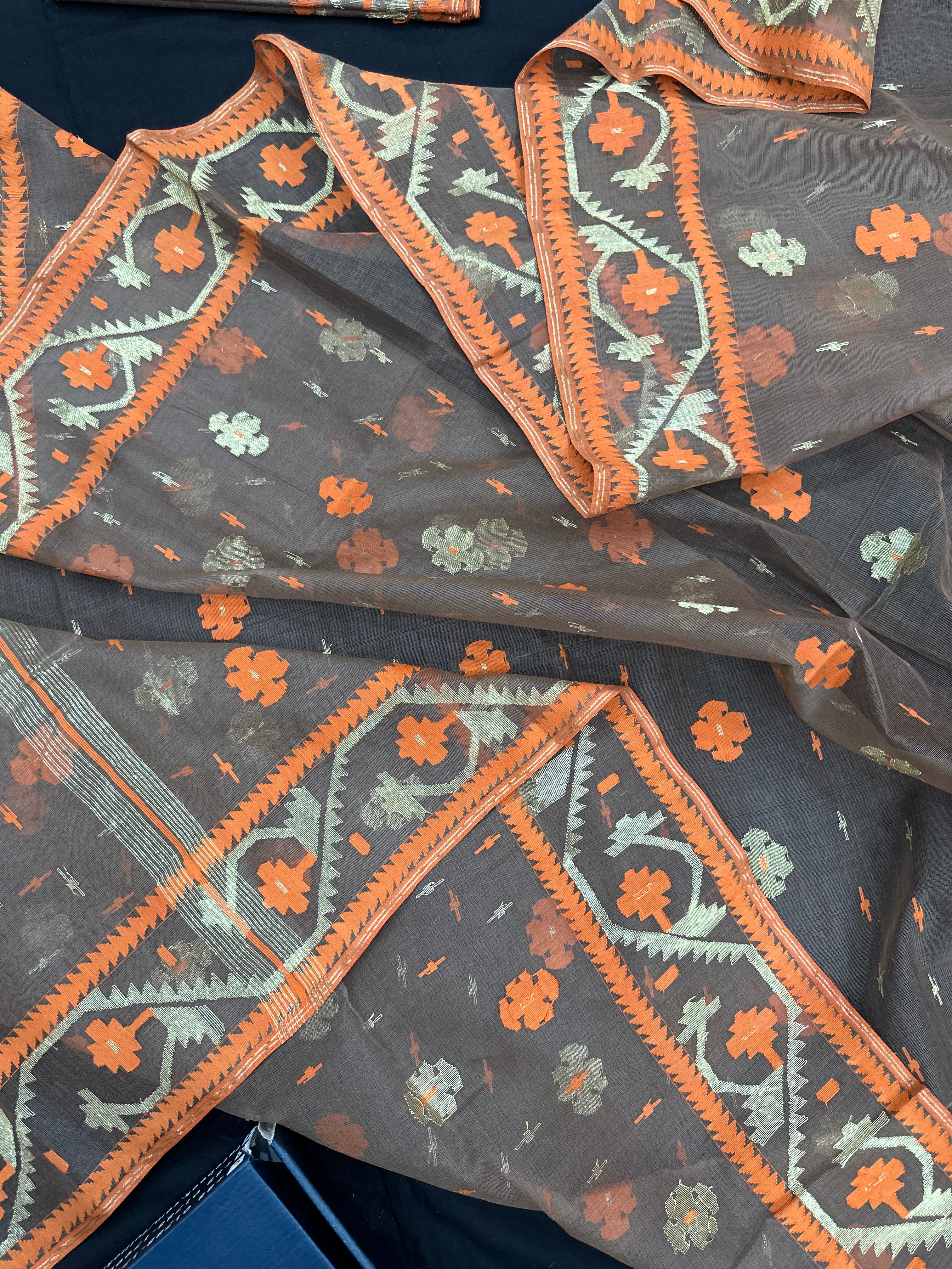 Peanut Brown dhakai jamdani saree with orange threads work & golden jori work all over soft count.