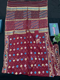 Maroon jamdani saree with golden jori work all over work with blouse piece.