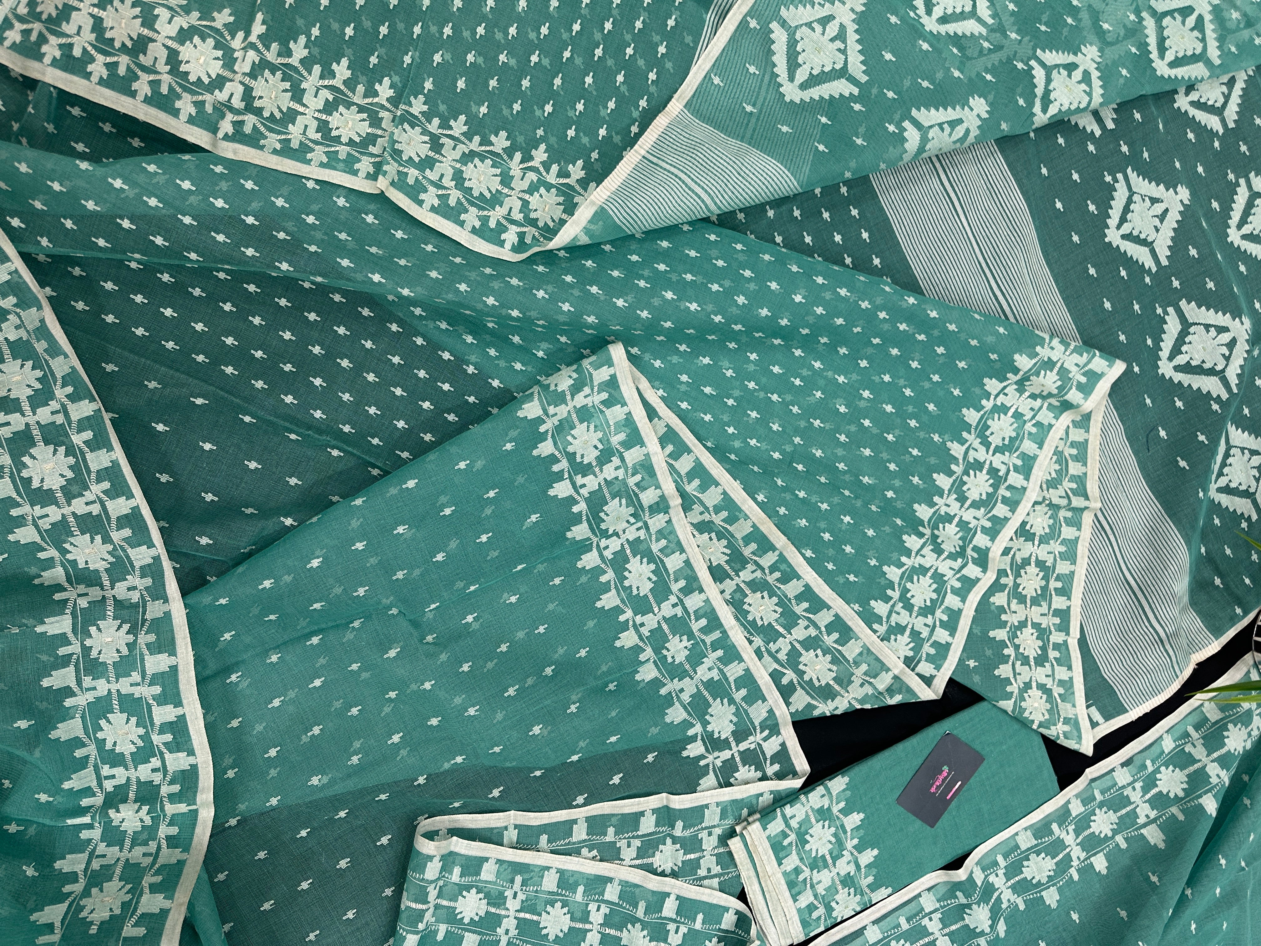Mint cotton jamdani saree with white threads work all over work and blouse piece.