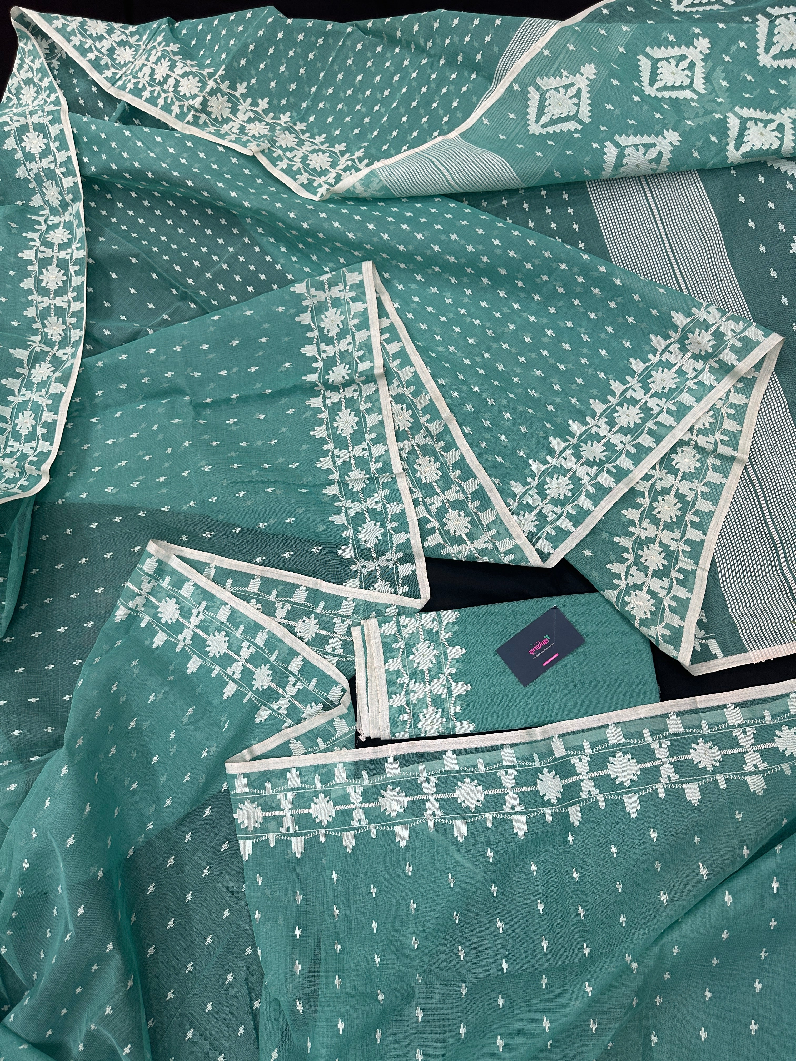 Mint cotton jamdani saree with white threads work all over work and blouse piece.