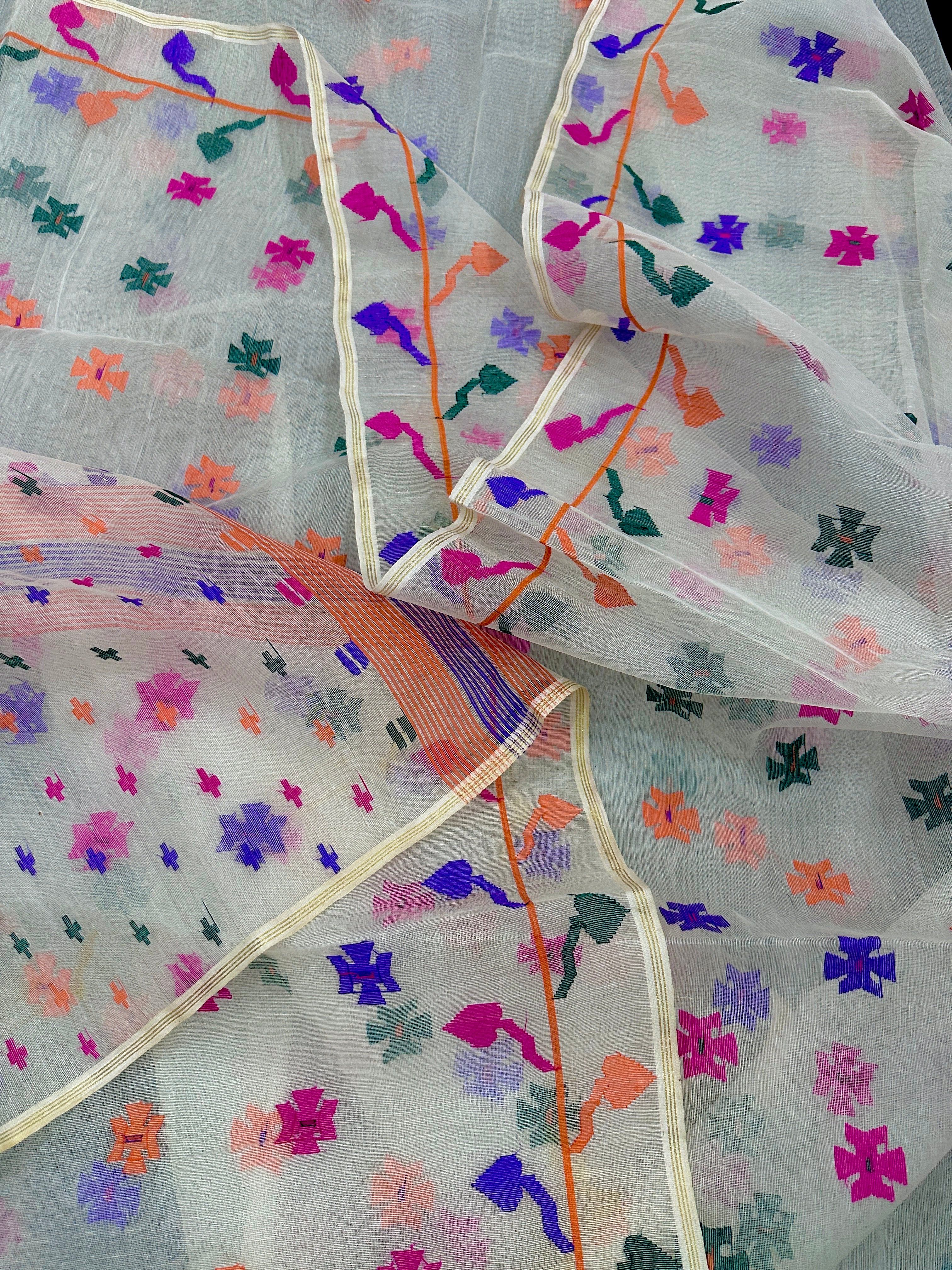 White jamdani saree with purple pink green orange threads work.