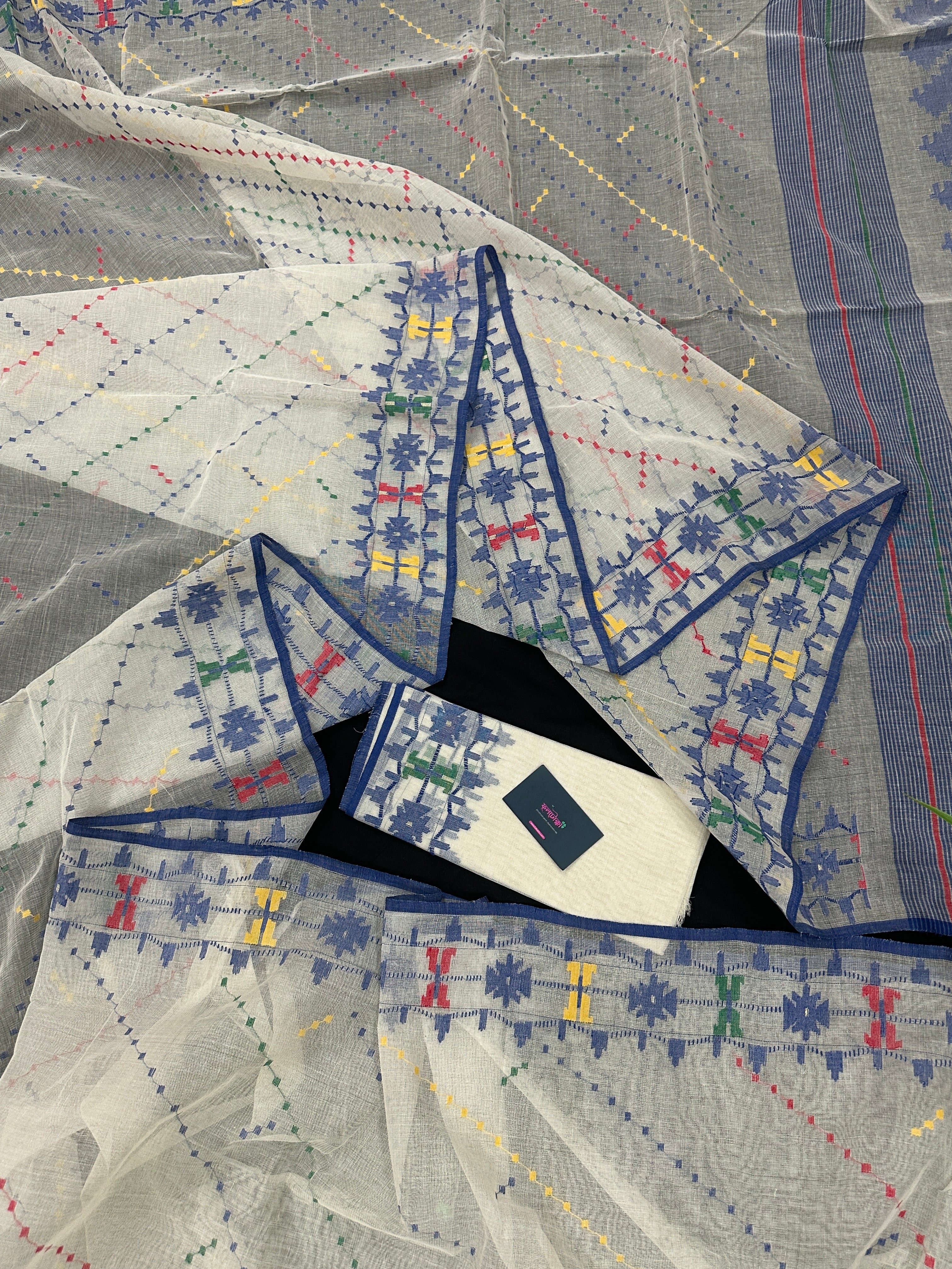 White cotton jamdani saree with blue yellow red green threads work& blouse piece.